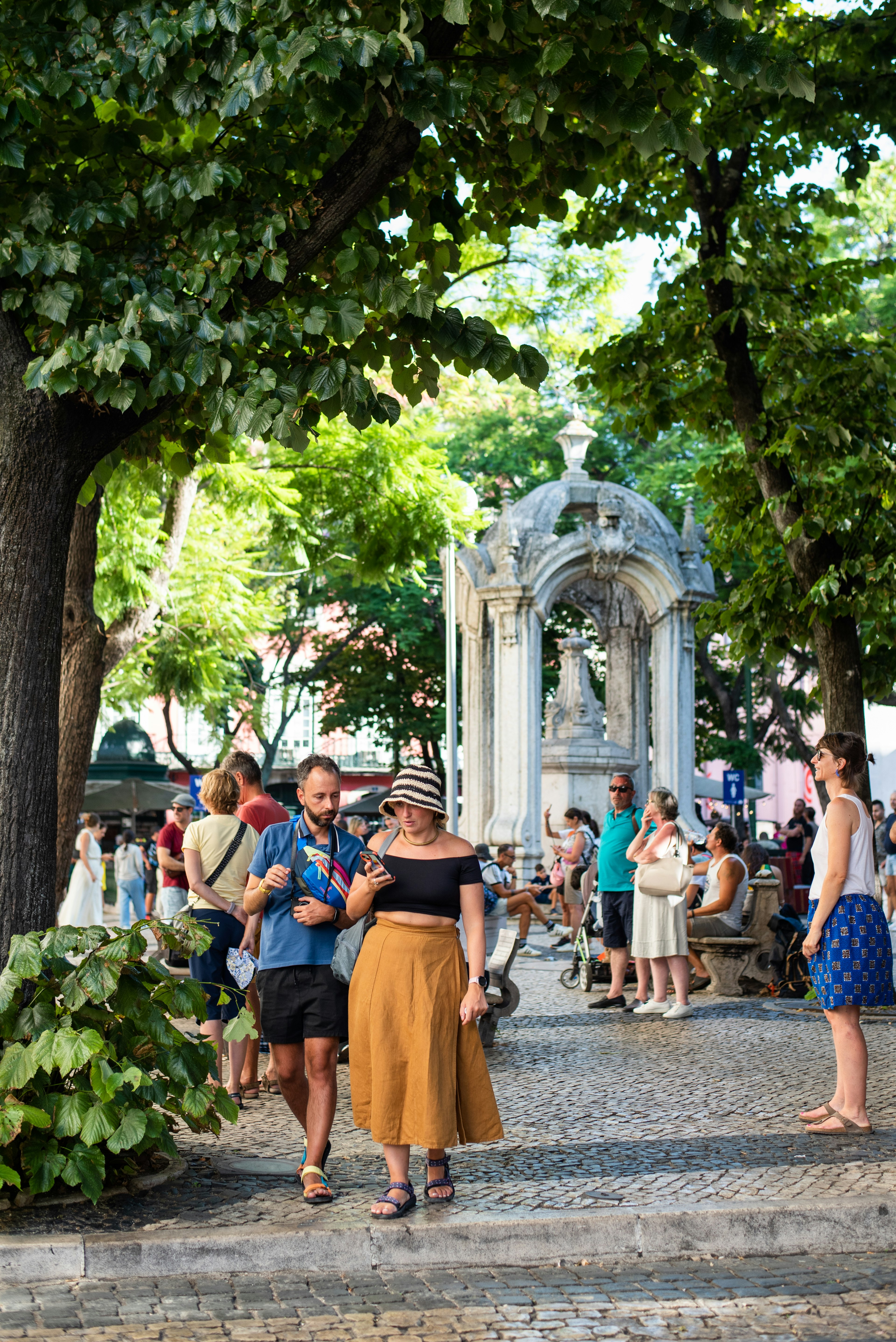 People wandering along a cobbled street in Chiado, Lisbon