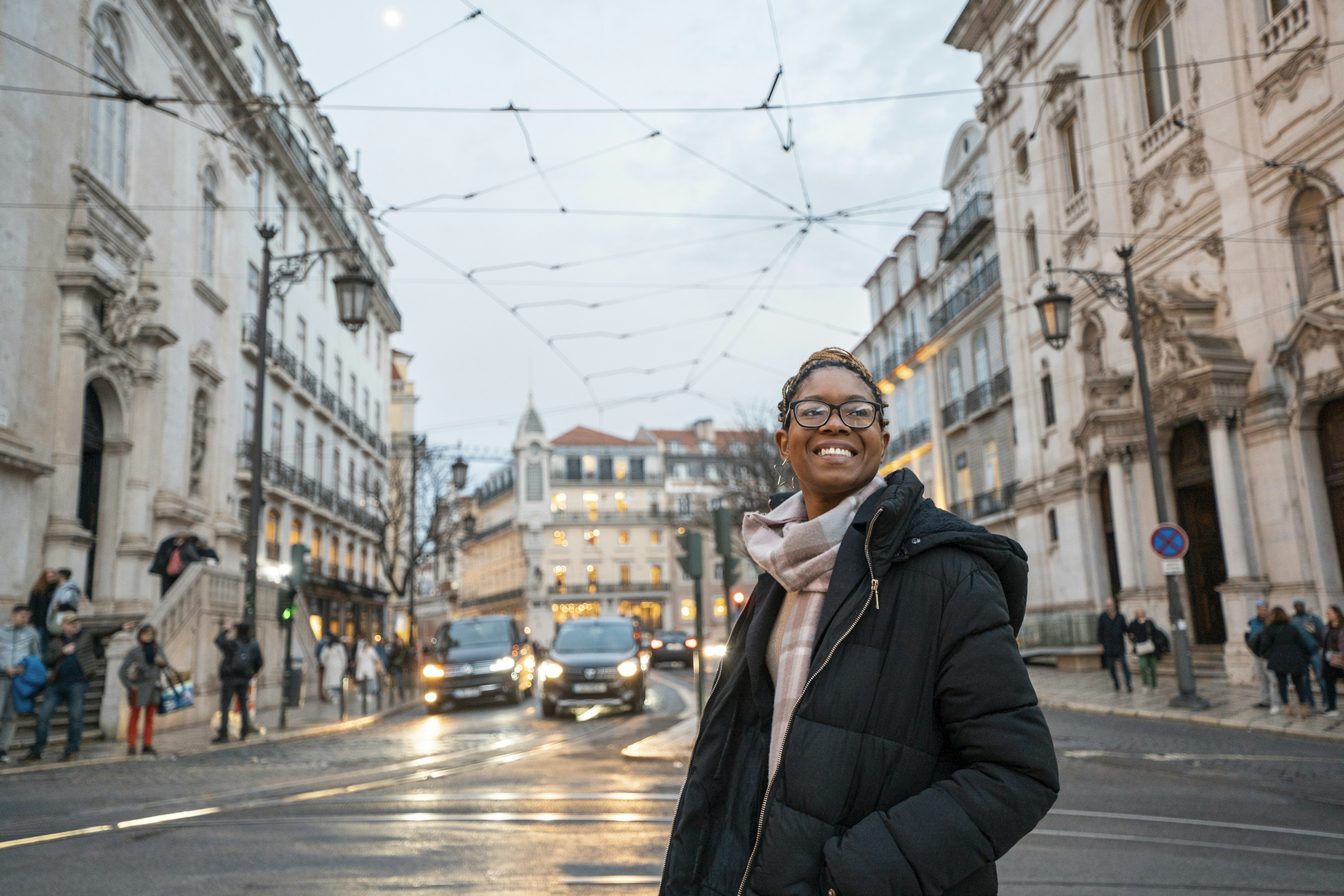 A Black woman exploring the streets of Lisbon, Portugal.