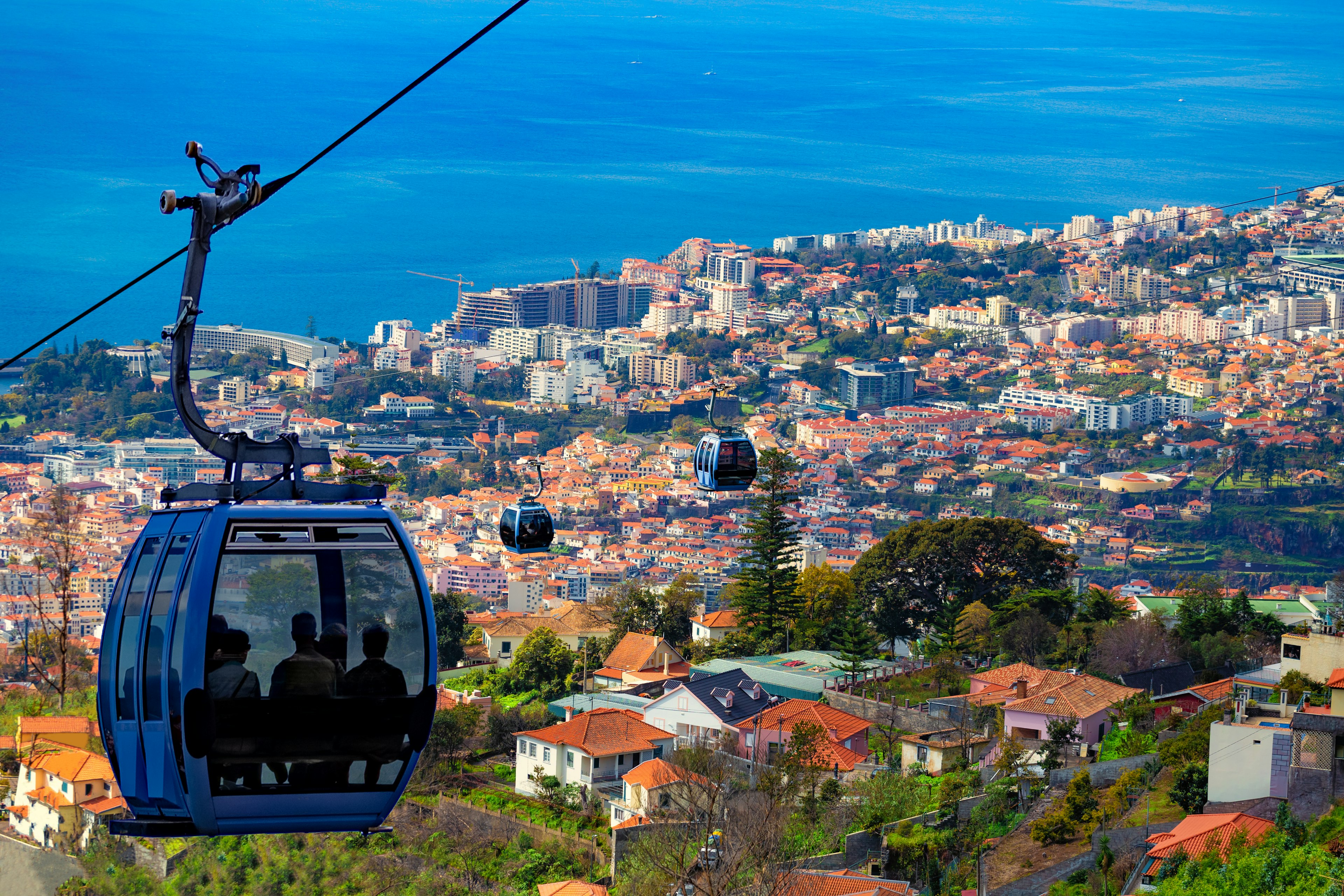 Aerial view of Funchal with traditional cable car above the city