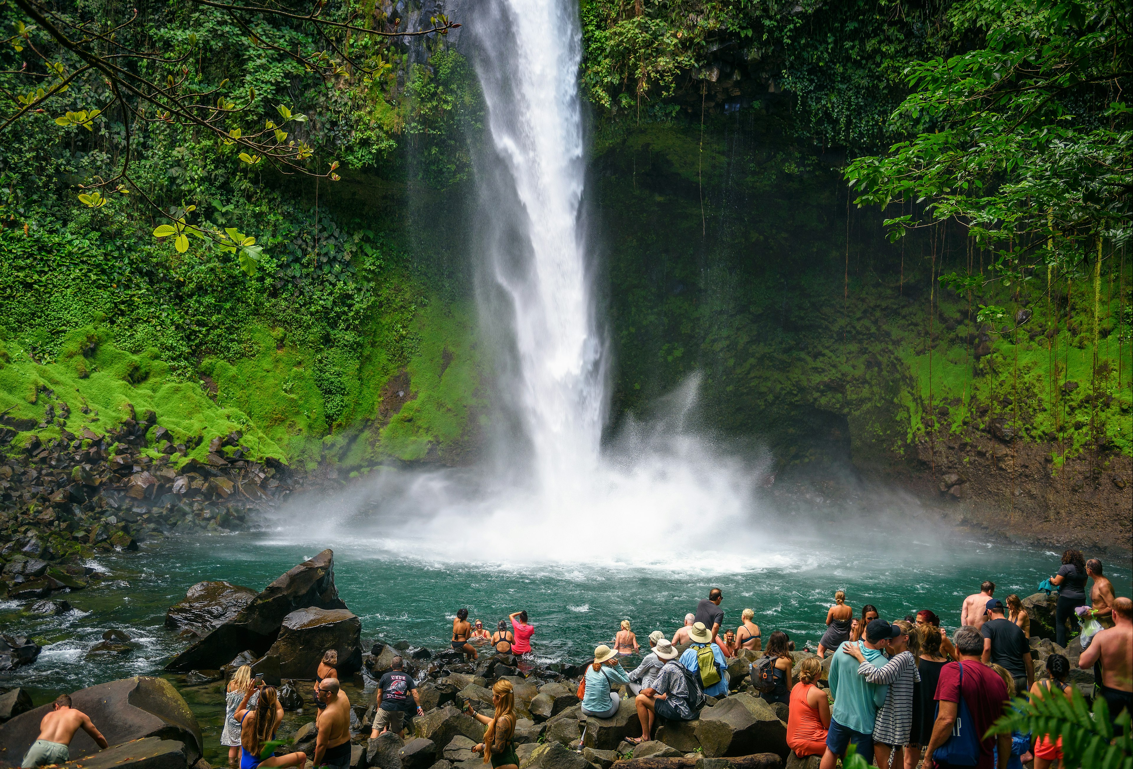 Tourists and locals visiting the La Fortuna waterfall. This scenic waterfall is located in the rain forest of Tenorio volcano national park.