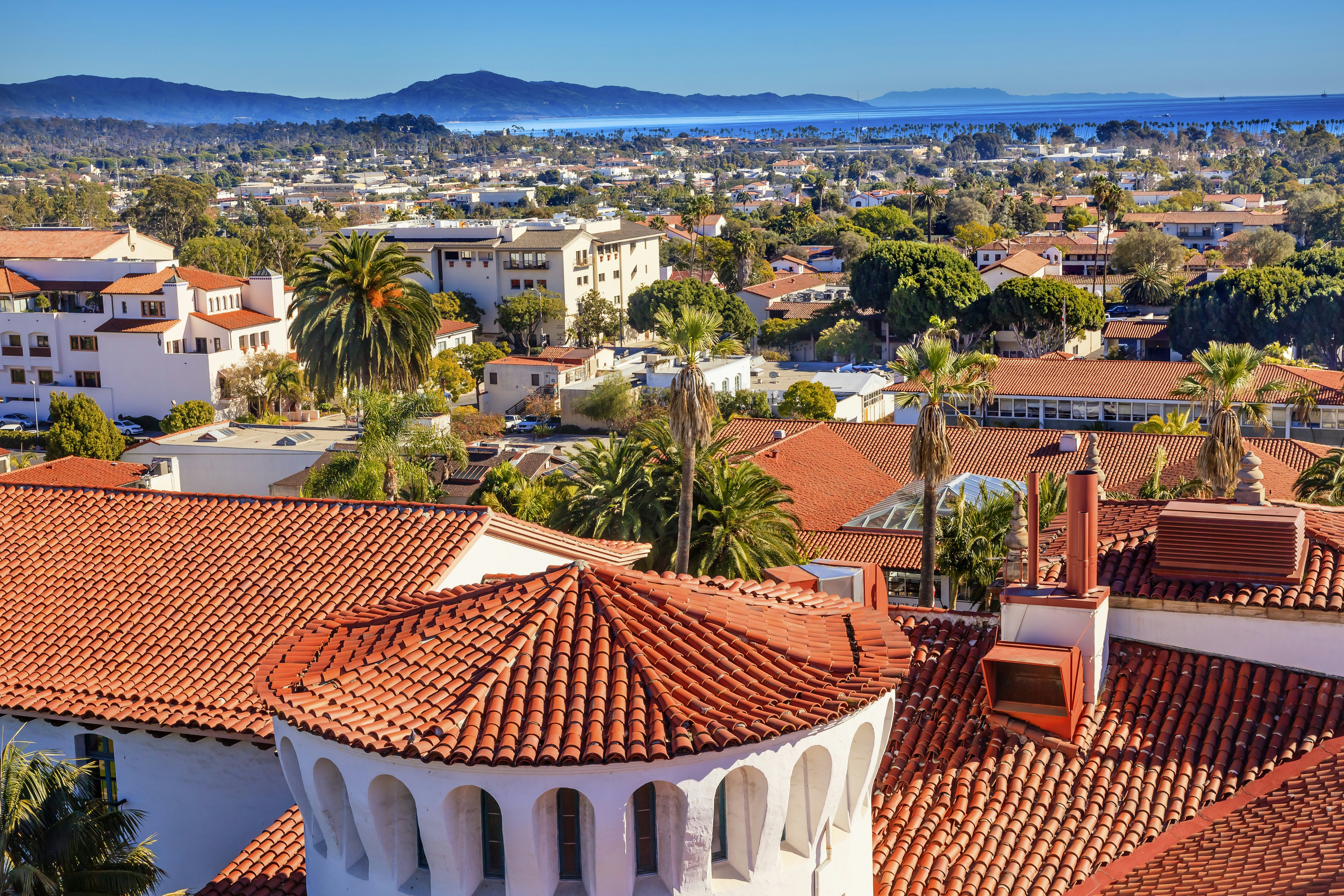 View of Santa Barbara red tile roofs, beach, and mountains
