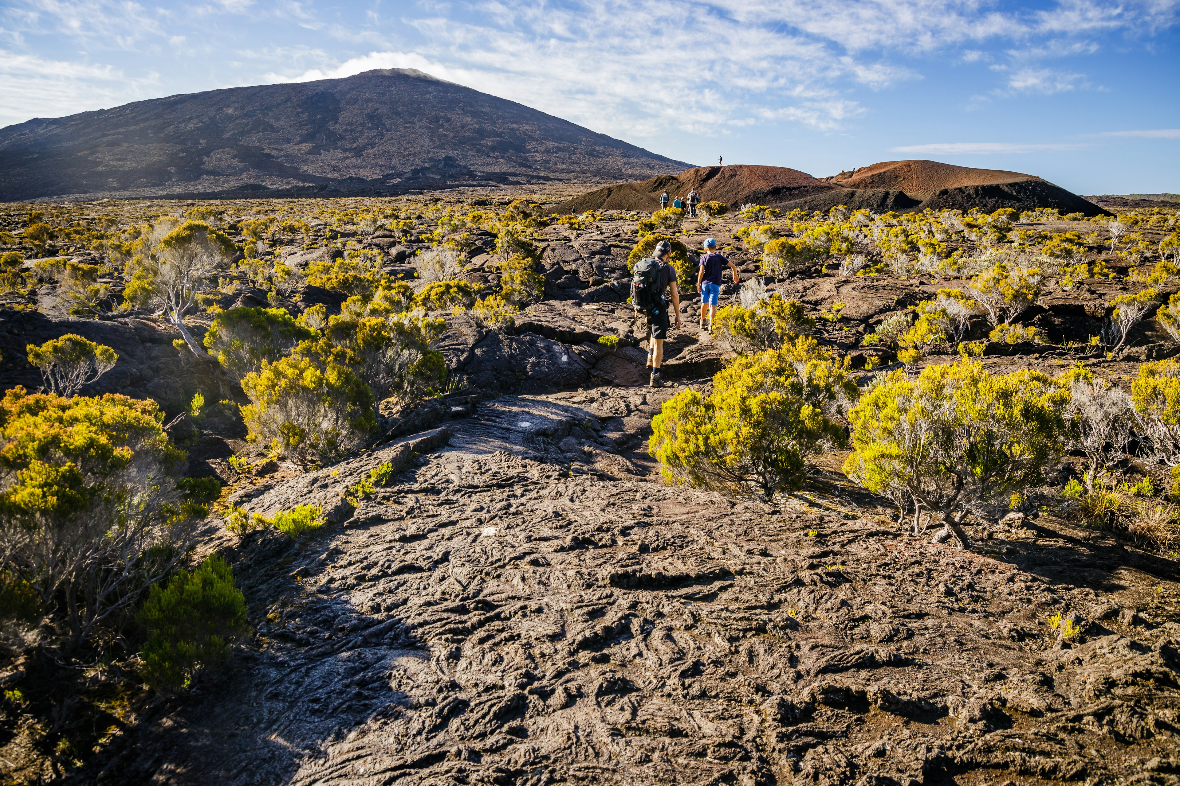 Hikers walking to the summit of the Piton de la Fournaise volcano