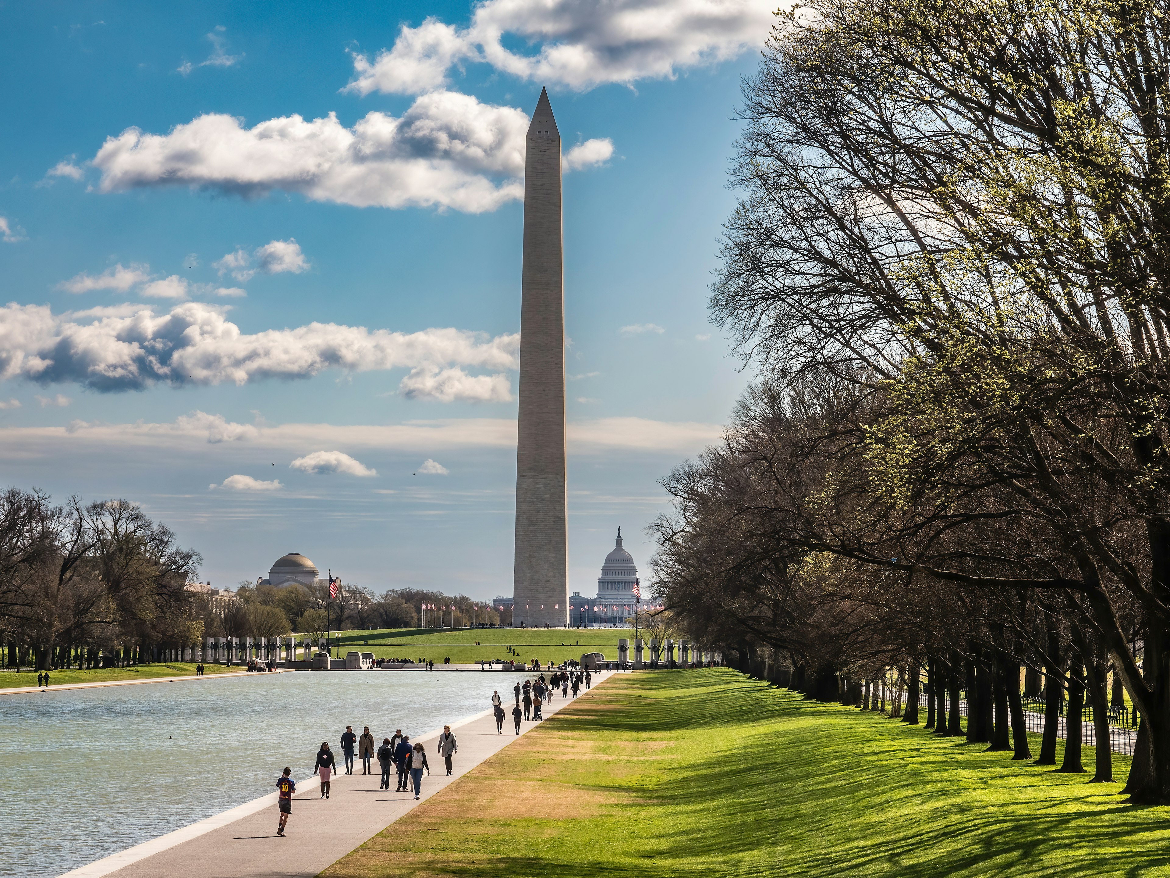 The Washington Monument dominates the National Mall, with the Capitol Building visible in the distance.
