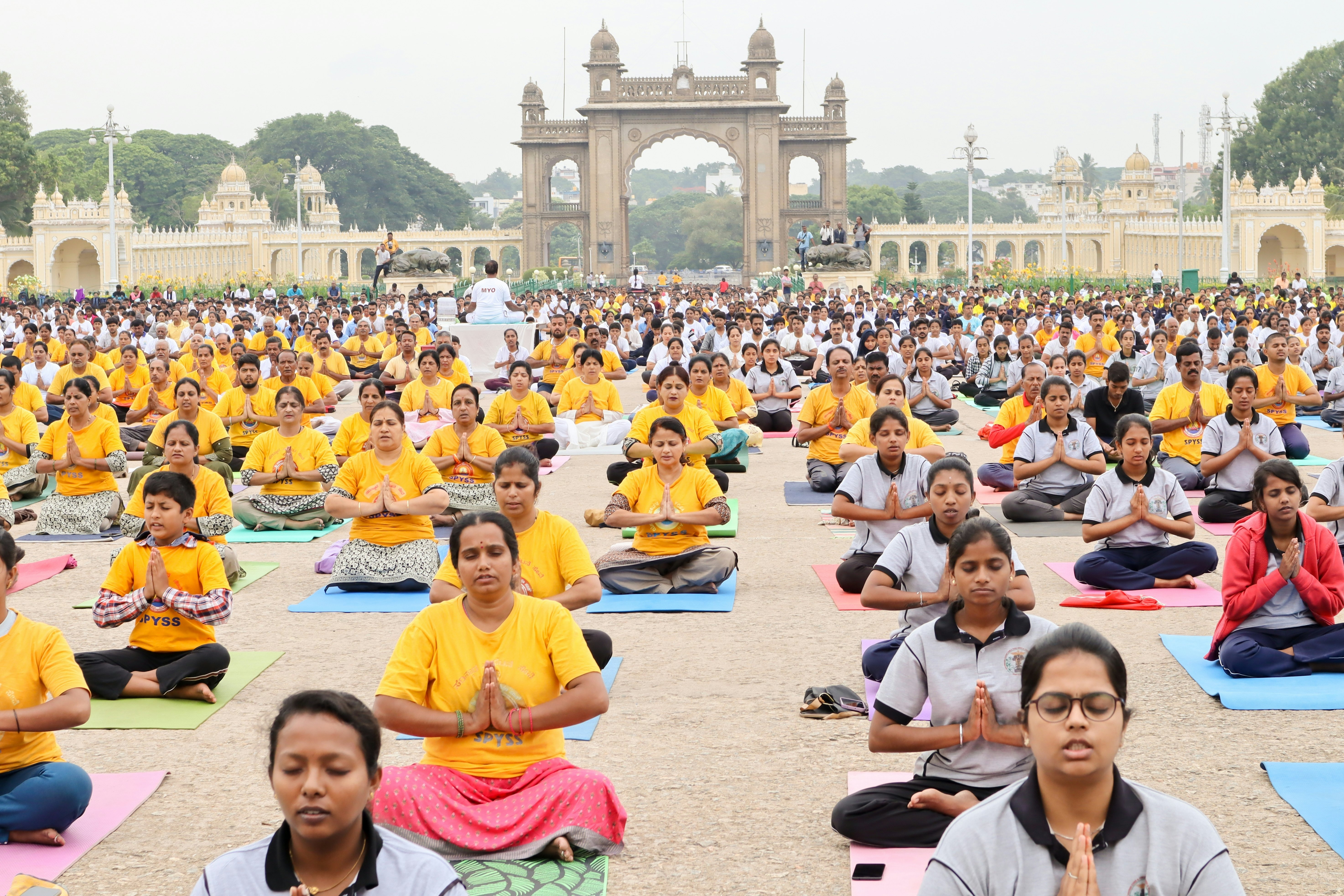 A large group of Yogis doing different Yogasanas in Mysore palace during International Yoga day in India.