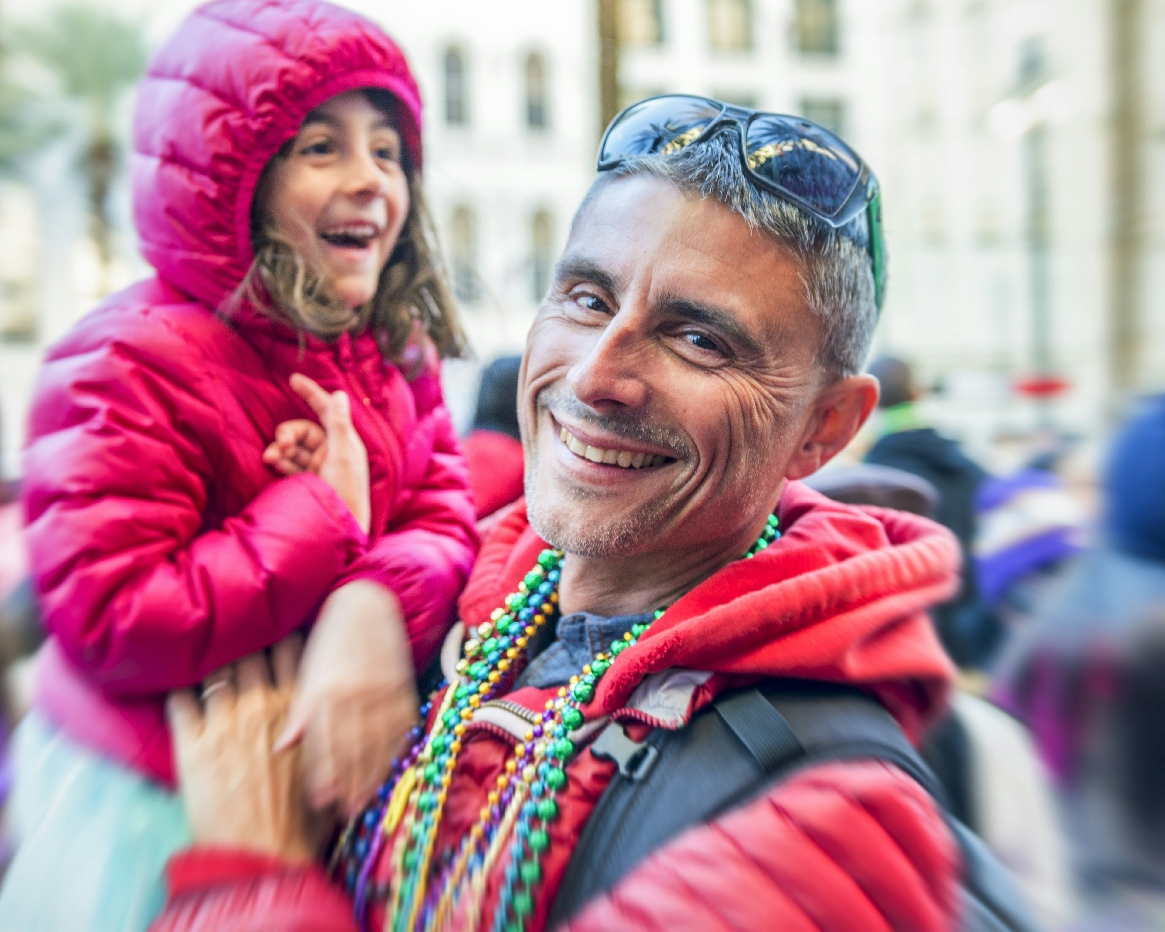 Father and daughter having fun in New Orleans street on Mardi Gras.