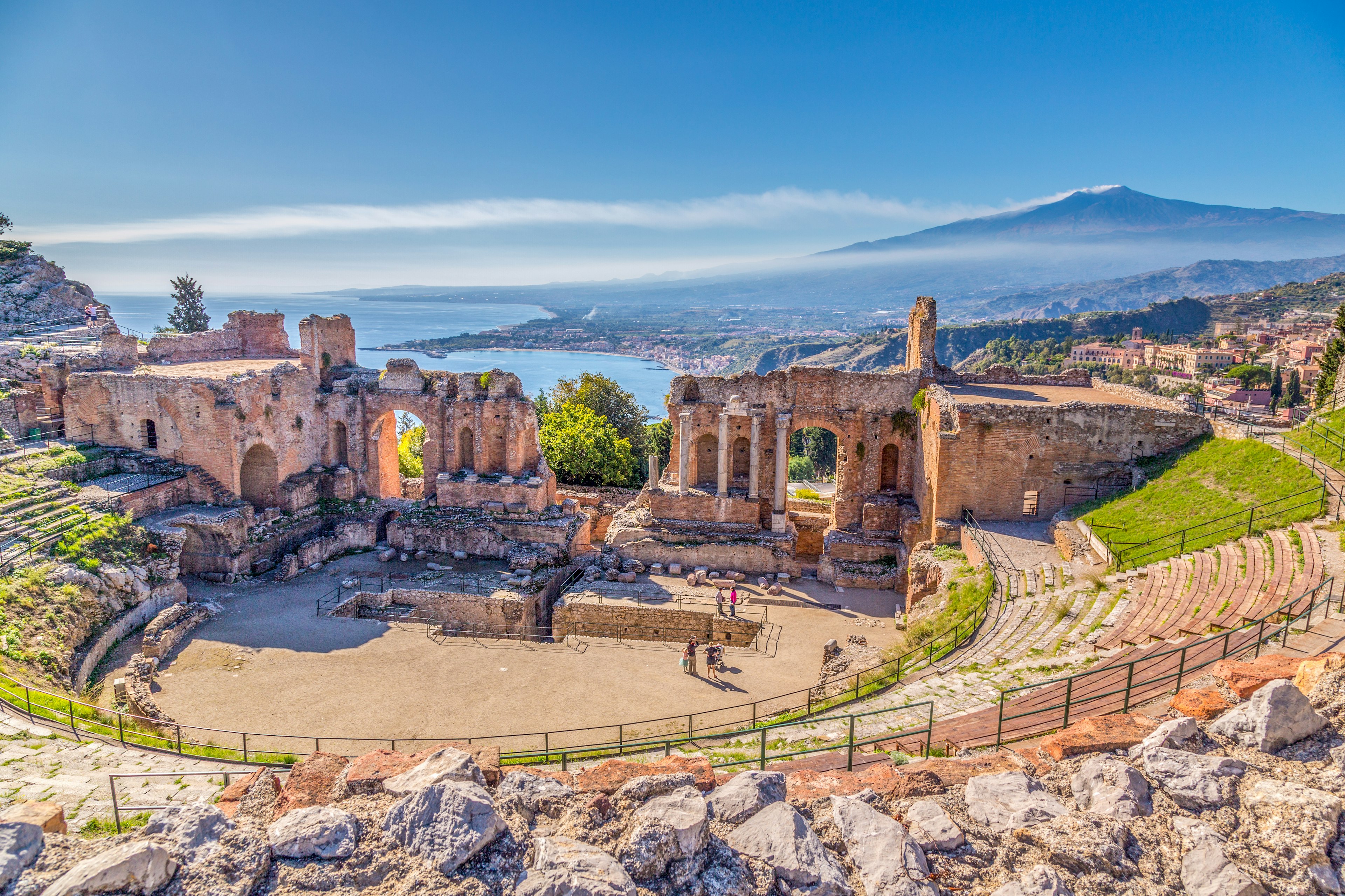 Ruins of the Ancient Greek Theater in Taormina, Sicily, with Etna rising behind.