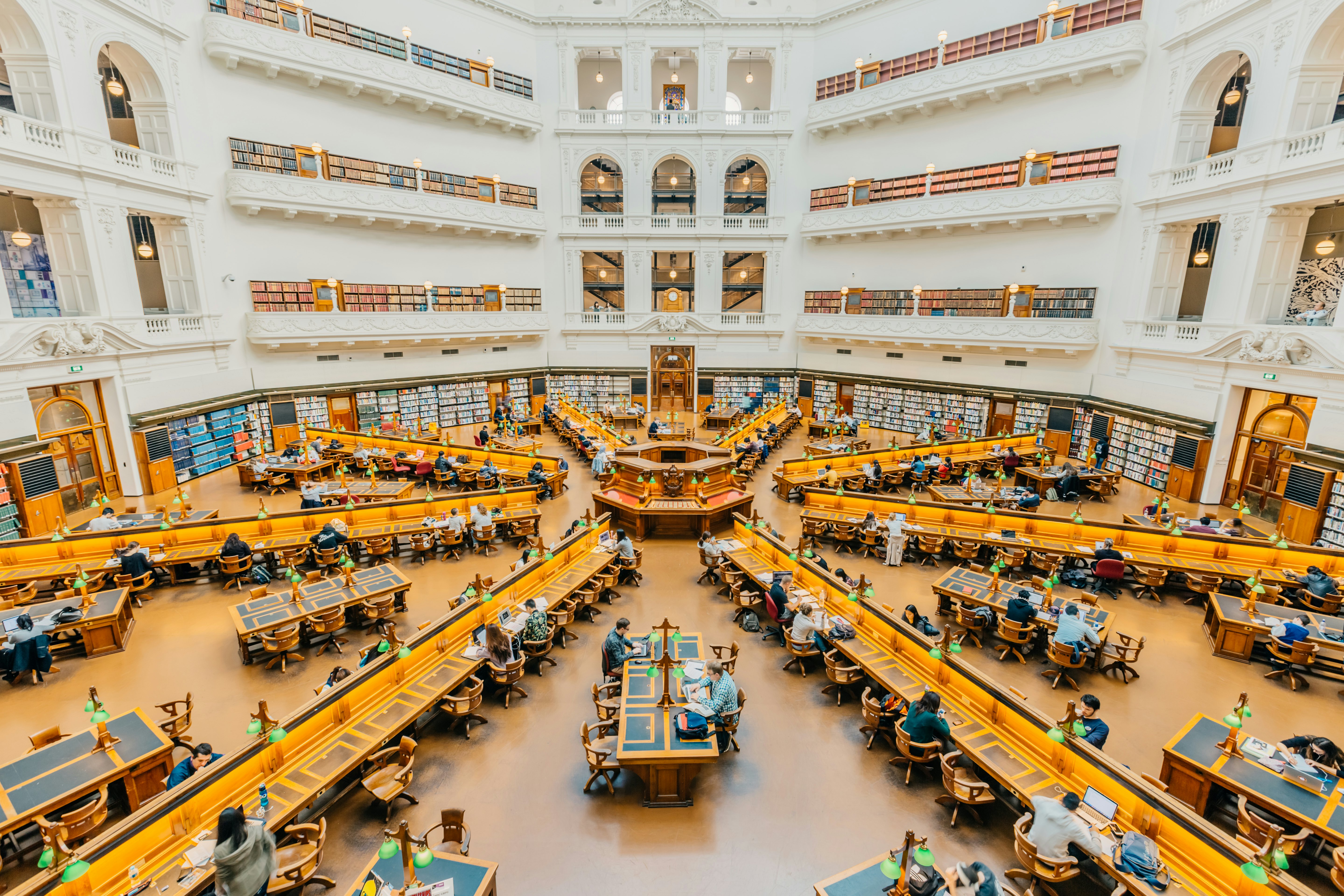 People studying in the reading room at the State Library of Victoria in Melbourne.