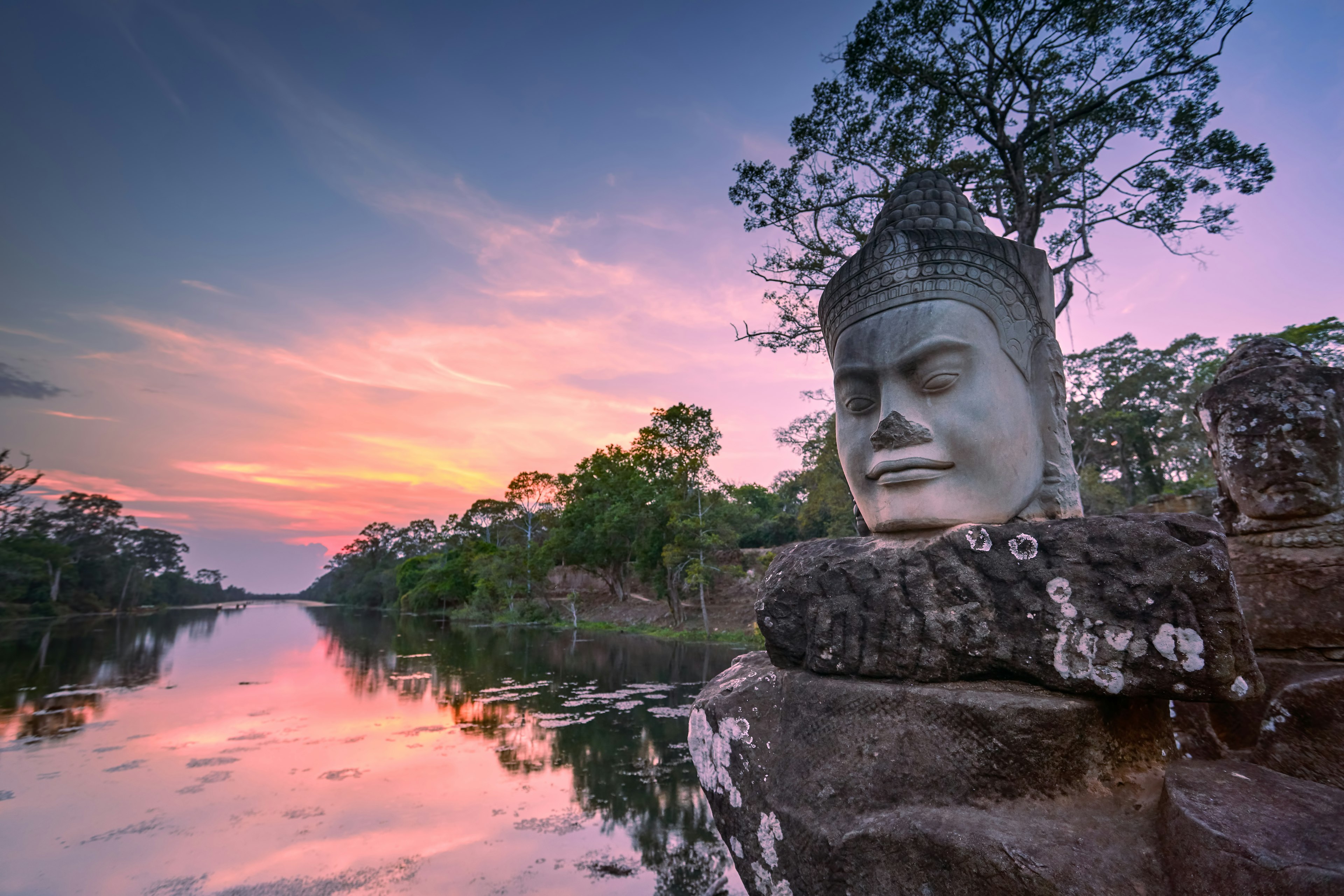 Sculpture outside the southern gate of Angkor Thom at sunset, Siem Reap, Cambodia.