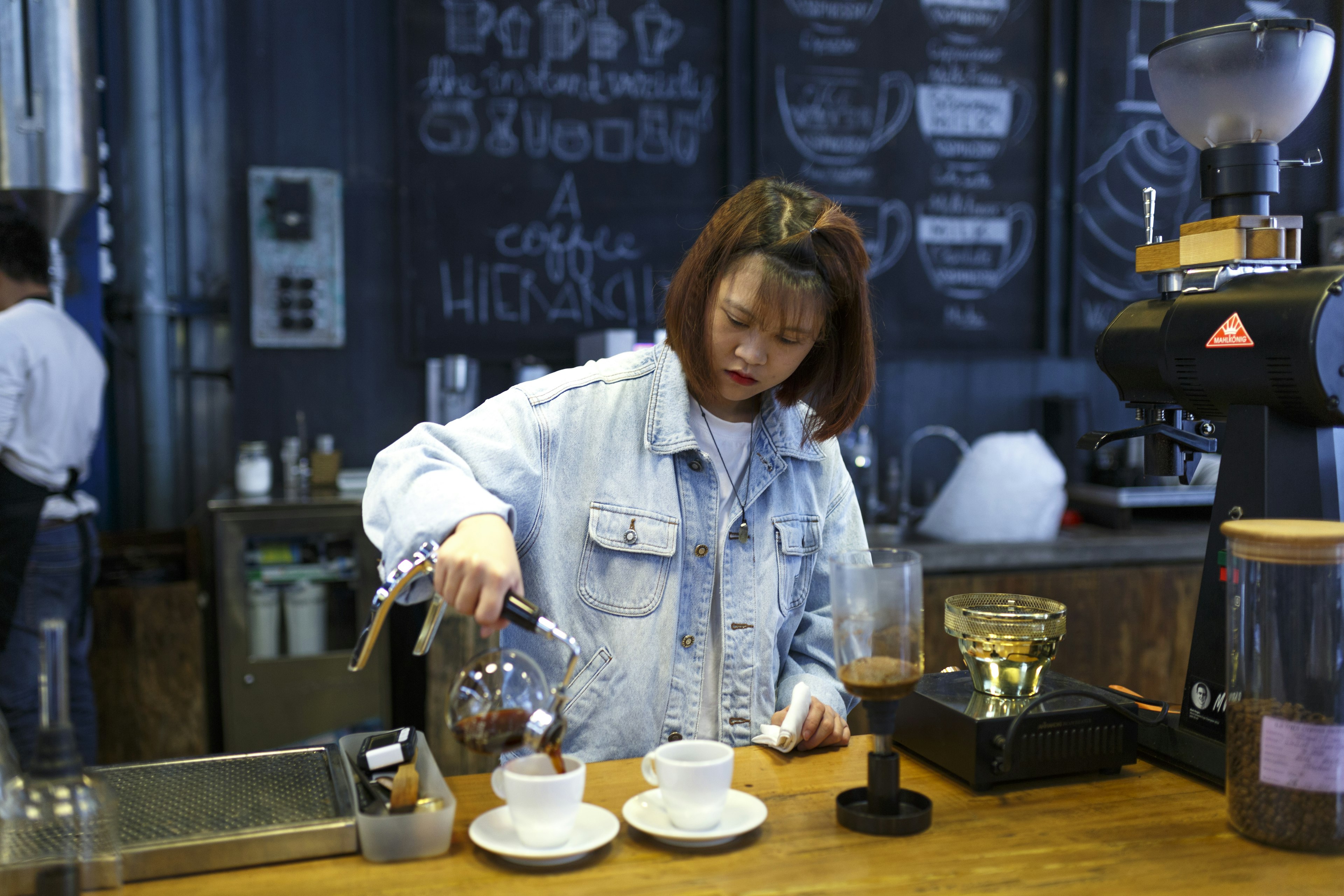 Barista making coffee. close up image of barista with siphon coffee maker at the "La Viet" cafe in Da Lat town, Vietnam .