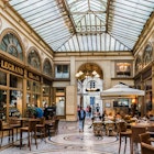 PARIS, FRANCE - MARCH 8, 2015: Interior of Galerie Vivienne (architect Francois-Jean Delannoy, 1823). Luxurious Vivienne Covered Passage is 176 metres long: shops, restaurants and tourist attraction. License Type: media Download Time: 2024-02-05T03:27:23.000Z User: mvm_lonelyplanet Is Editorial: Yes purchase_order: