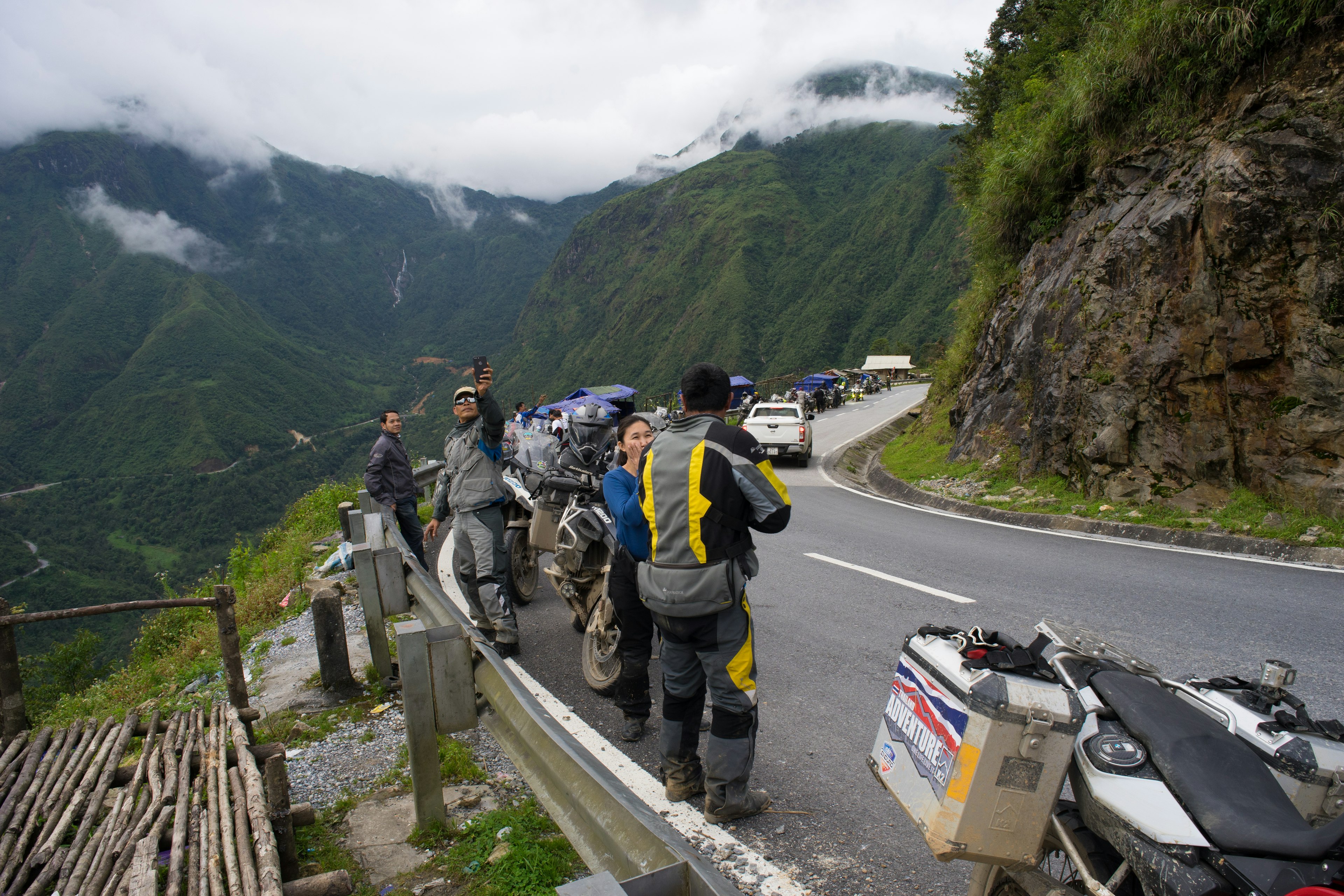 A group of powerful motocycle drivers from Thailand is taking a break and enjoy the beautiful landscape at O Quy Ho Mountain Pass.