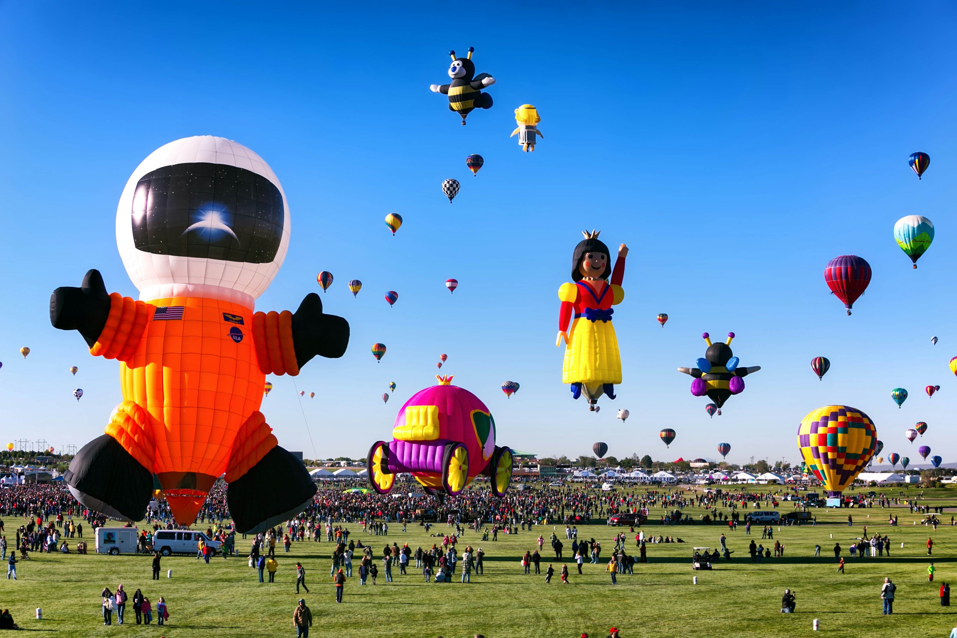 ALBUQUERQUE, NM - OCTOBER 06, 2013: Hot Air Baloon Fiesta in Albuquerque, New Mexico with a variety of interestingly shaped balloons, an astronaut, a carriage a princess and other colorful balloons.