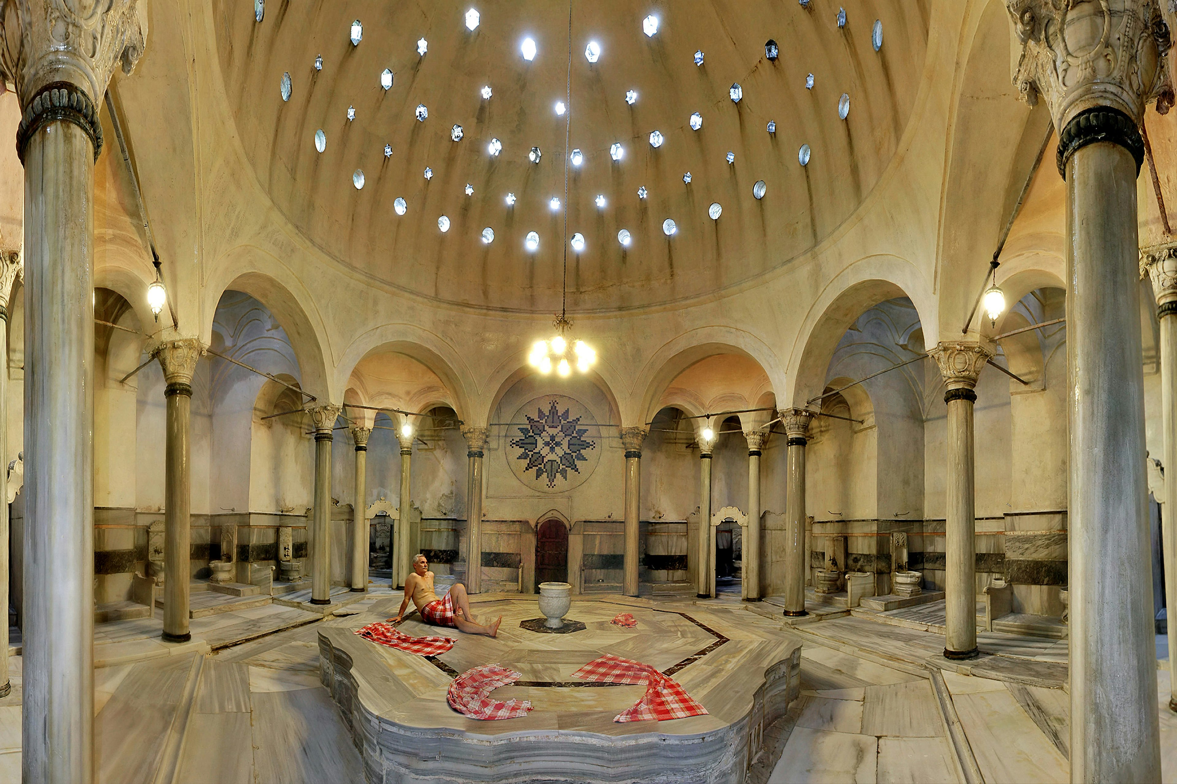 A man relaxes in the marble interior of the Cagaloglu Hammam in Istanbul.