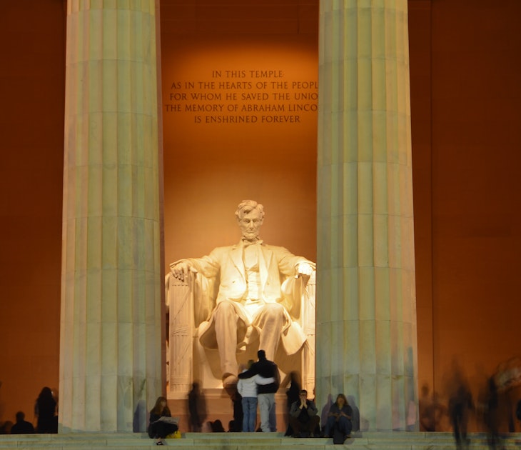 Visitors at the Lincoln Memorial in Washington, DC at night.