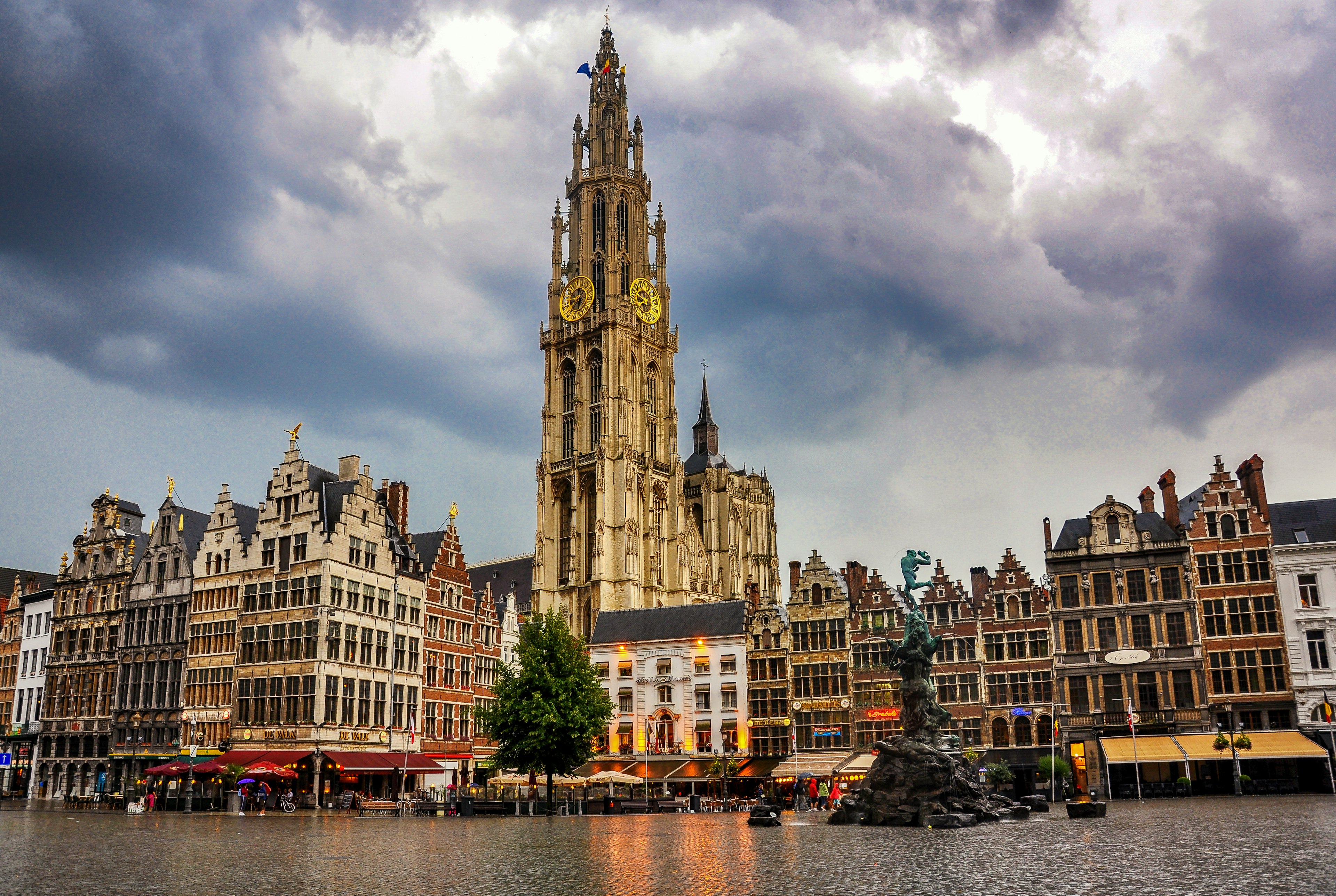 A large city square dominated by a cathedral with a huge spire