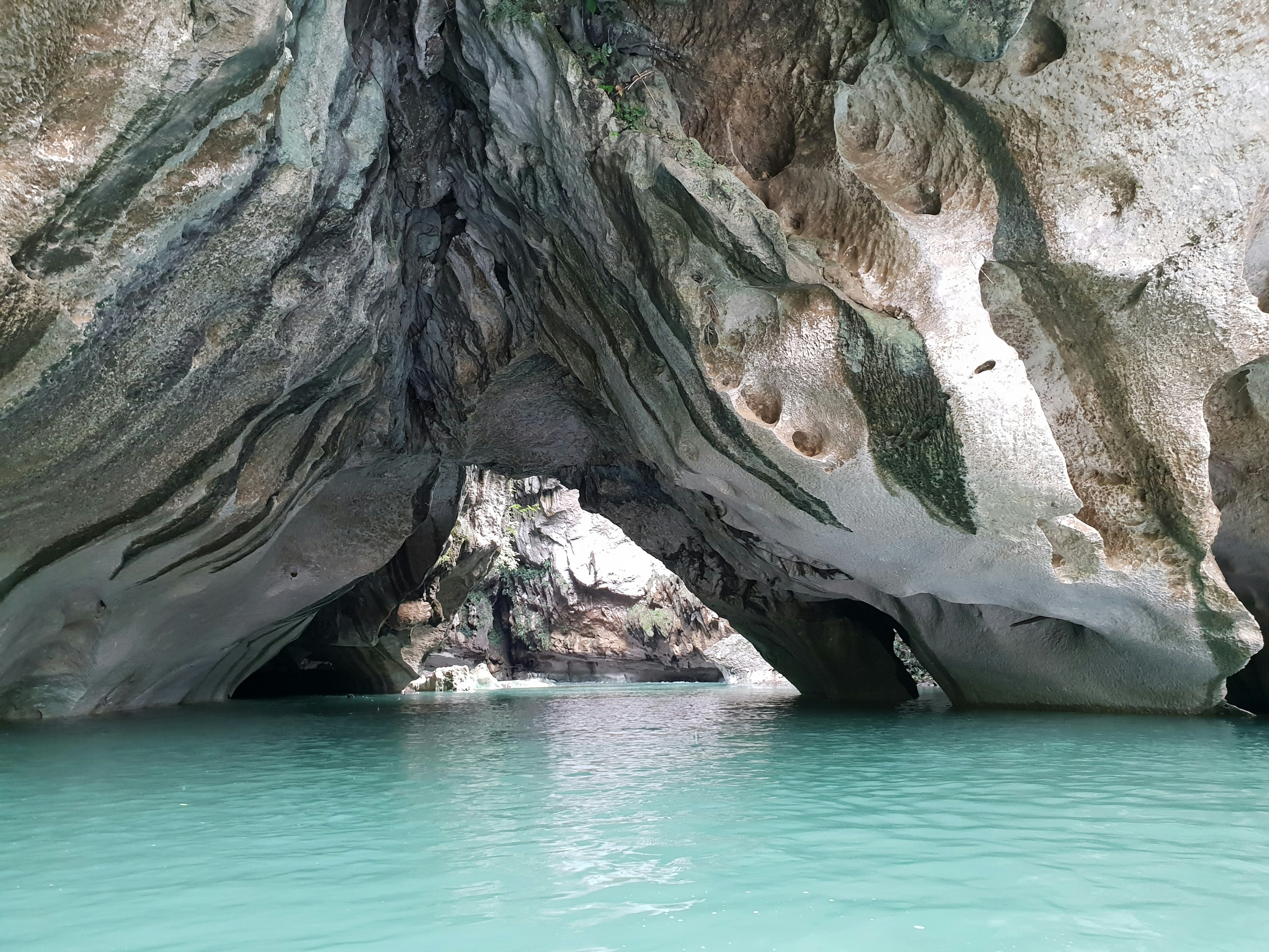 A natural rock bridge over azure waters in a tropical island