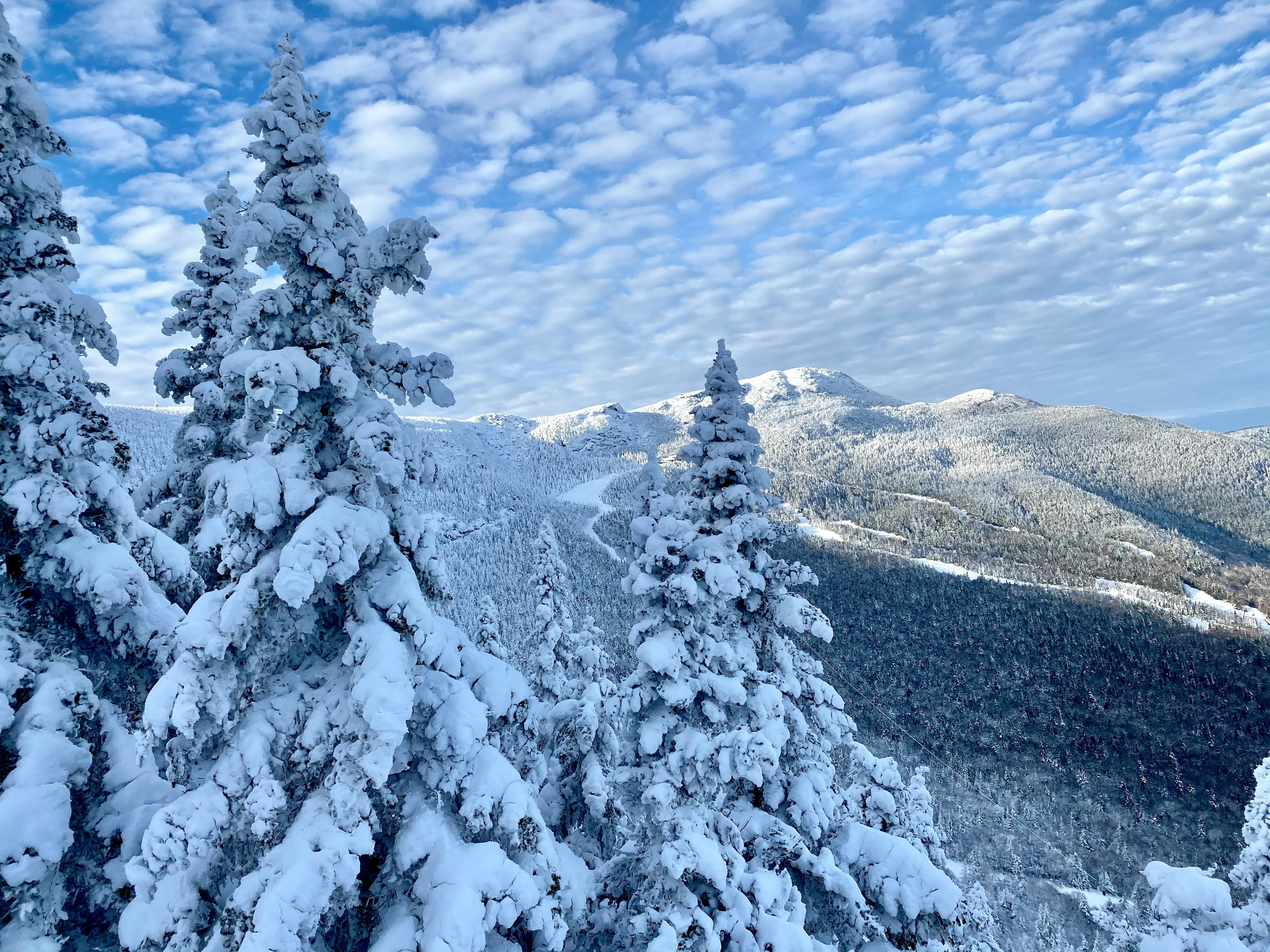 Beautiful sunny day with blue sky and white clouds at the Stowe Mountain Ski resort Vermont - December 2020