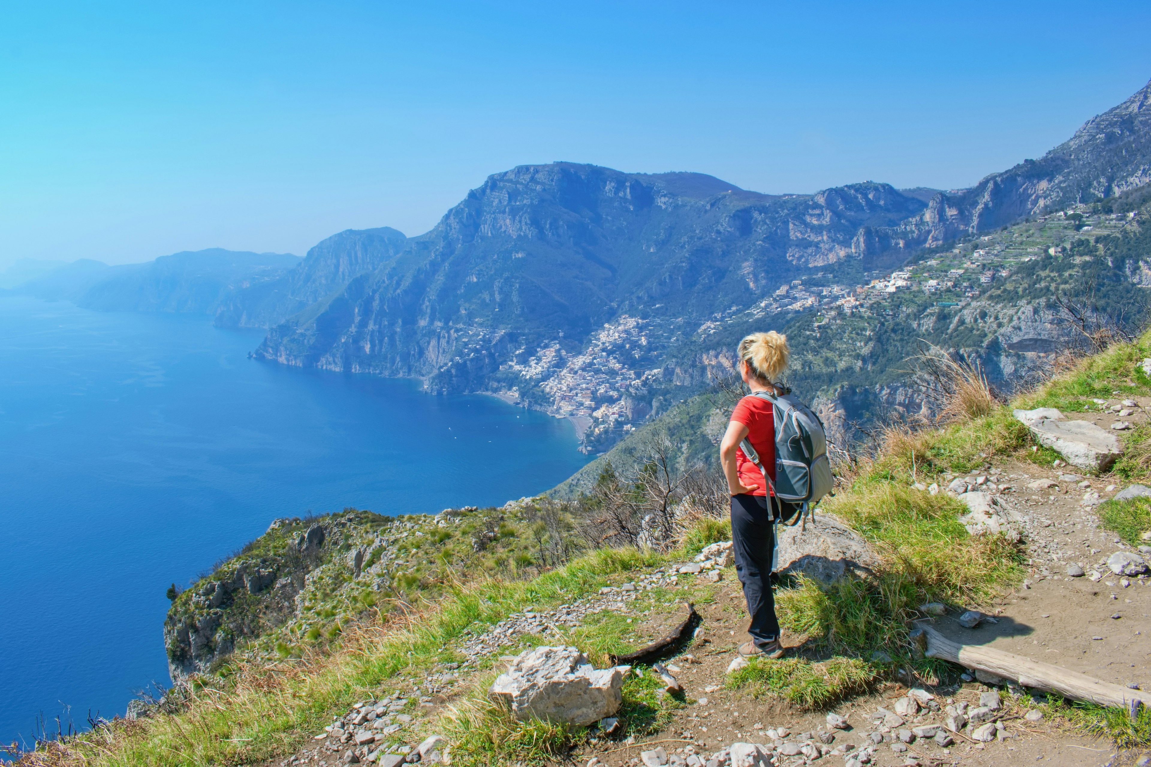 A hiker looks out over beautiful costal scenery