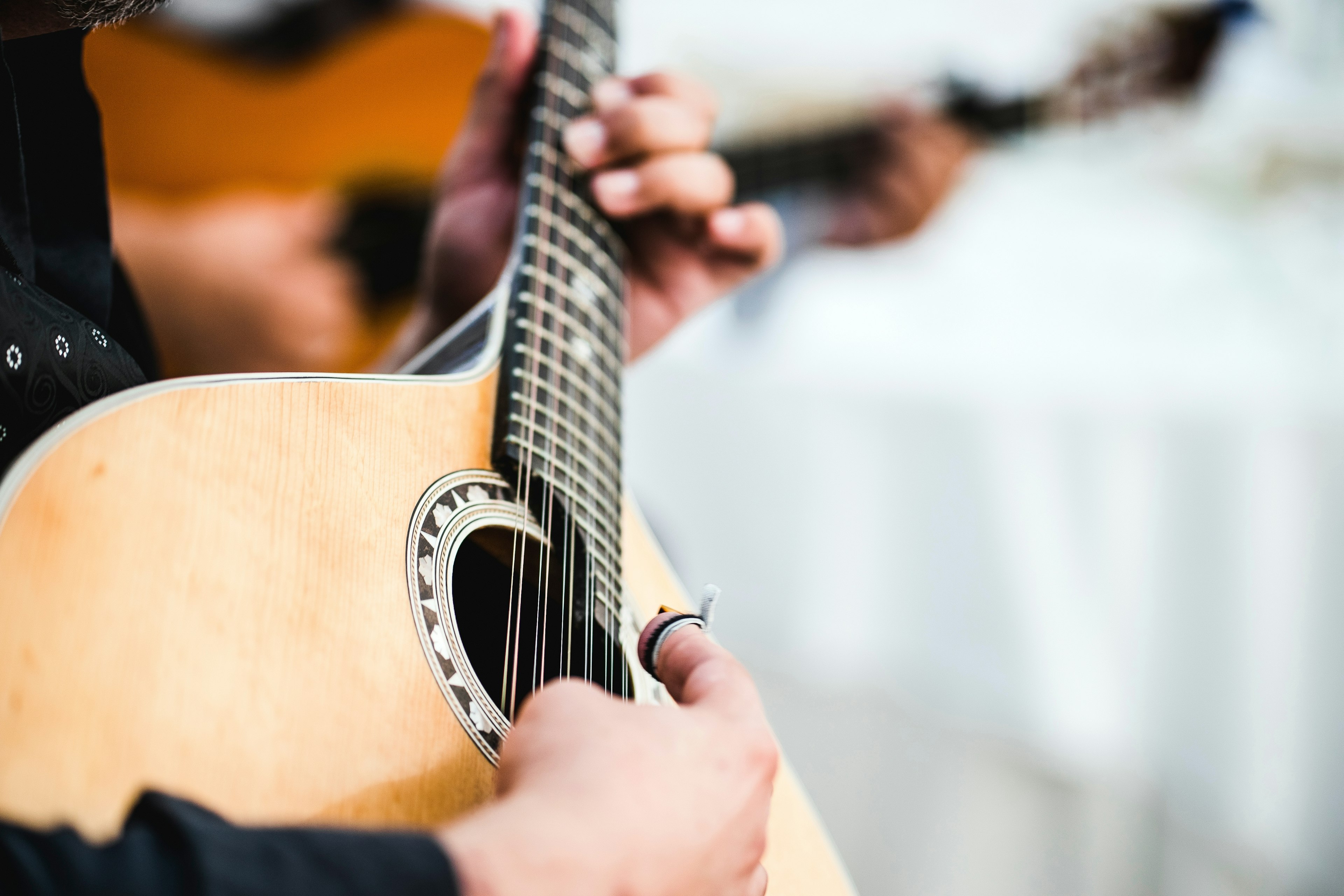 Close up of the guitar of a man playing traditional Portuguese music called fado.