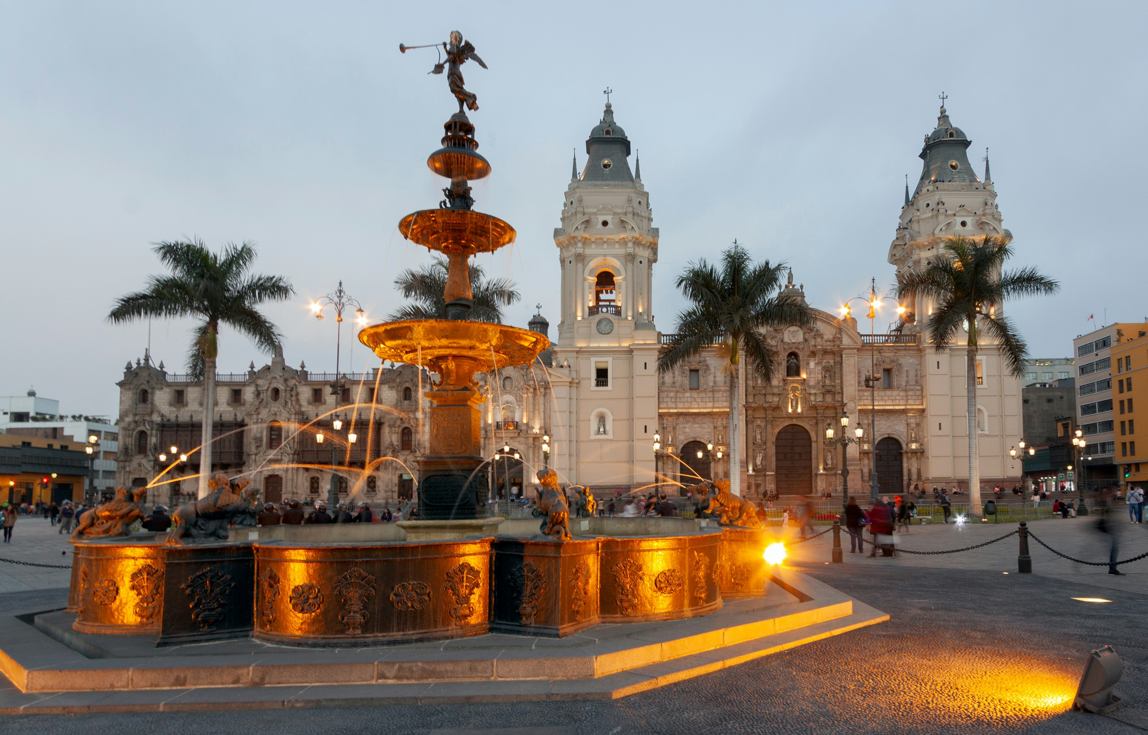 Main Square or Plaza Mayor or Plaza de Armas of Lima in the Historic Center of town, surrounded by colonial buildings at dusk.