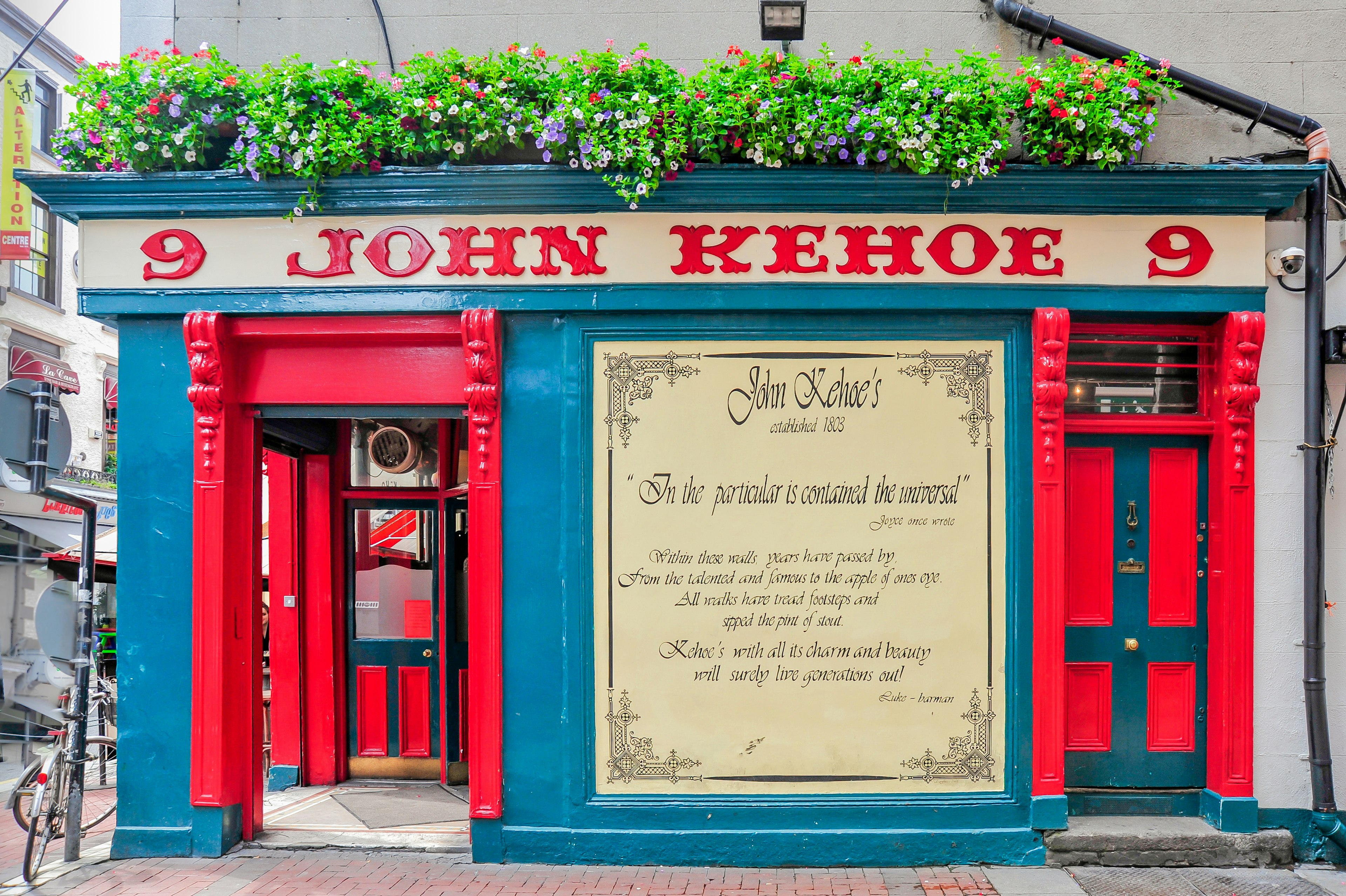 Exterior of Kehoe's pub with flower boxes adorning the shop sign.