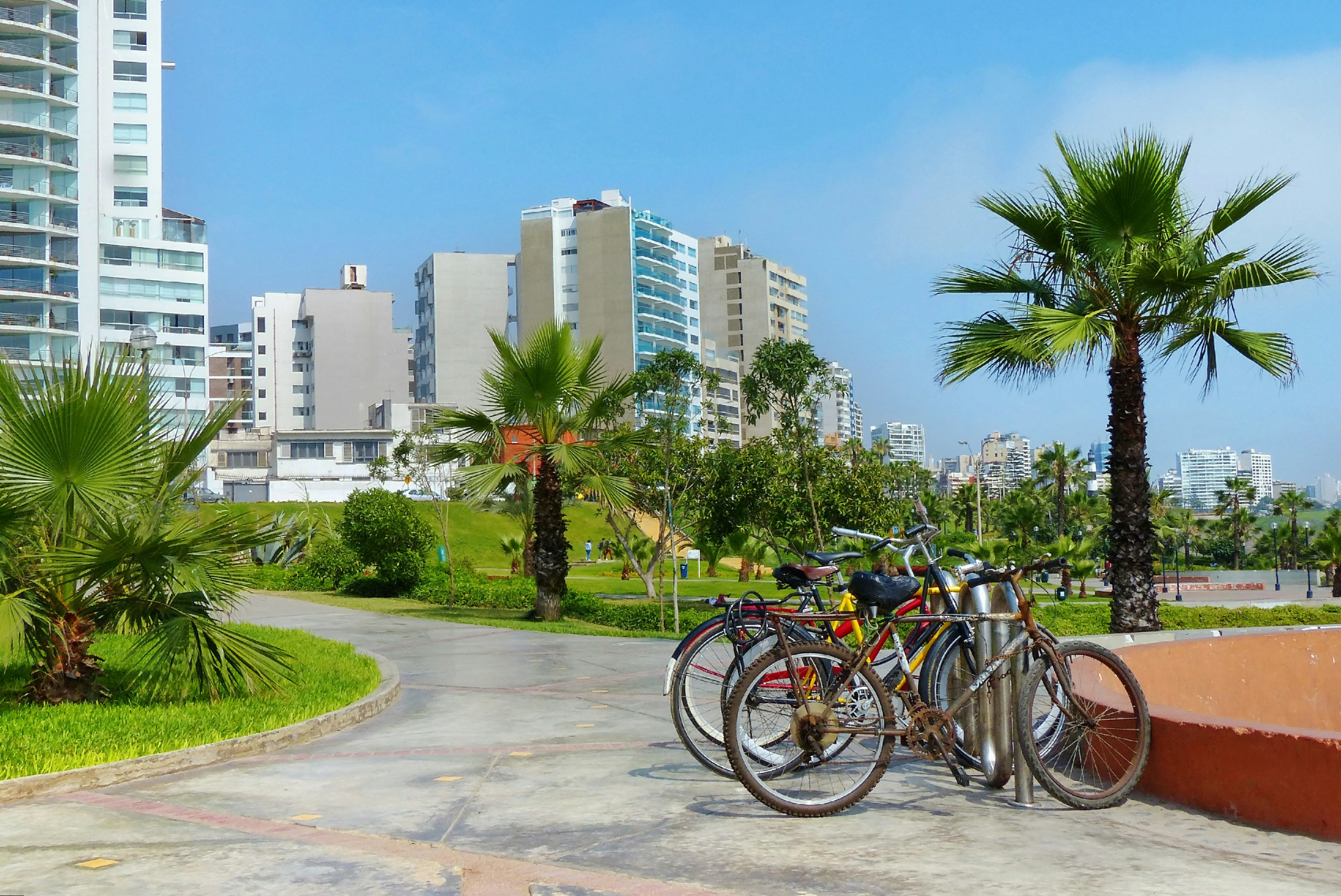 Modern buildings and park area in Miraflores district. Bicycles on the site for the rent in Lima, Peru