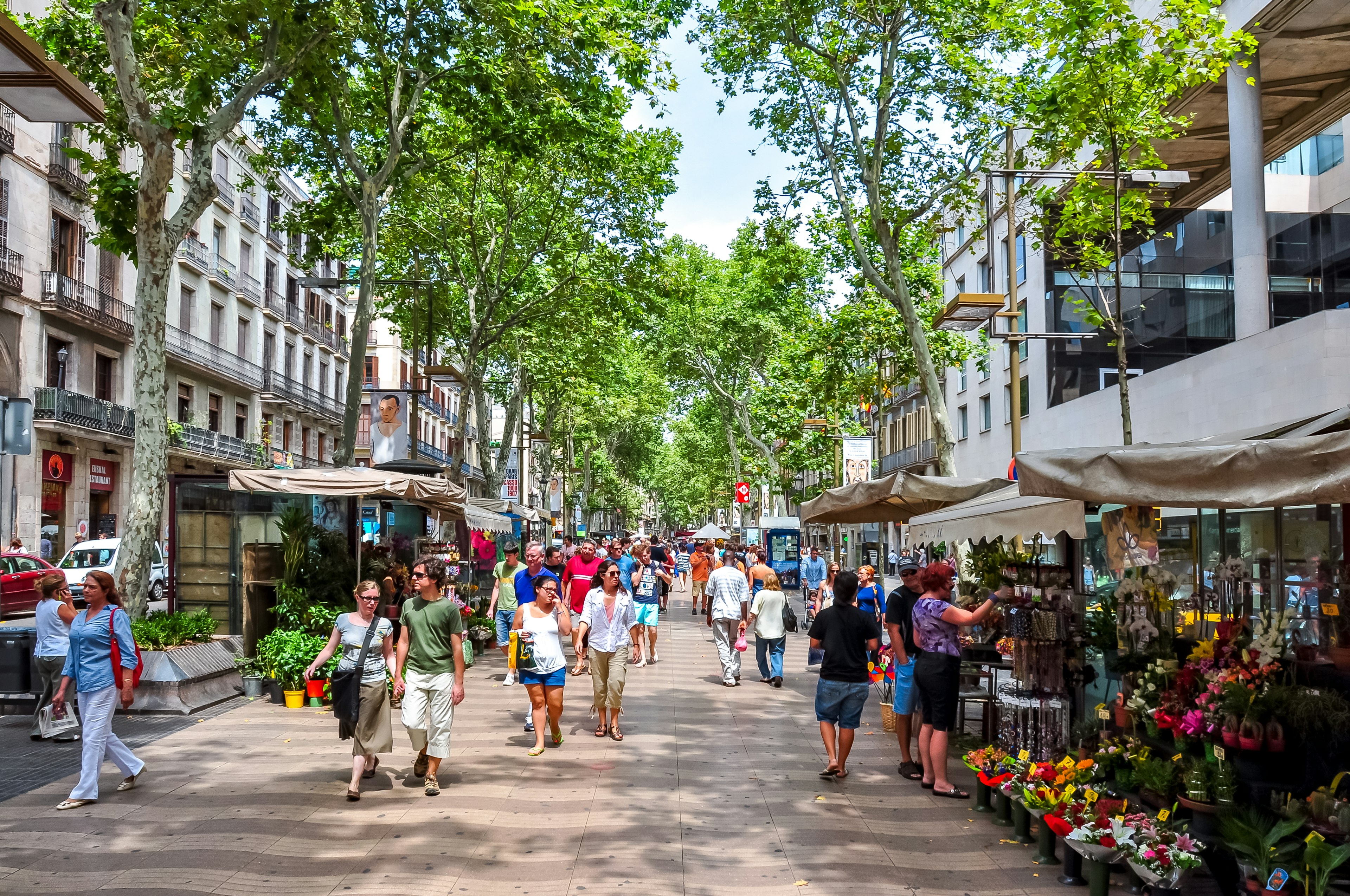 Barcelona, Spain - June 2018: People walking on La Rambla (central street of Barcelona)