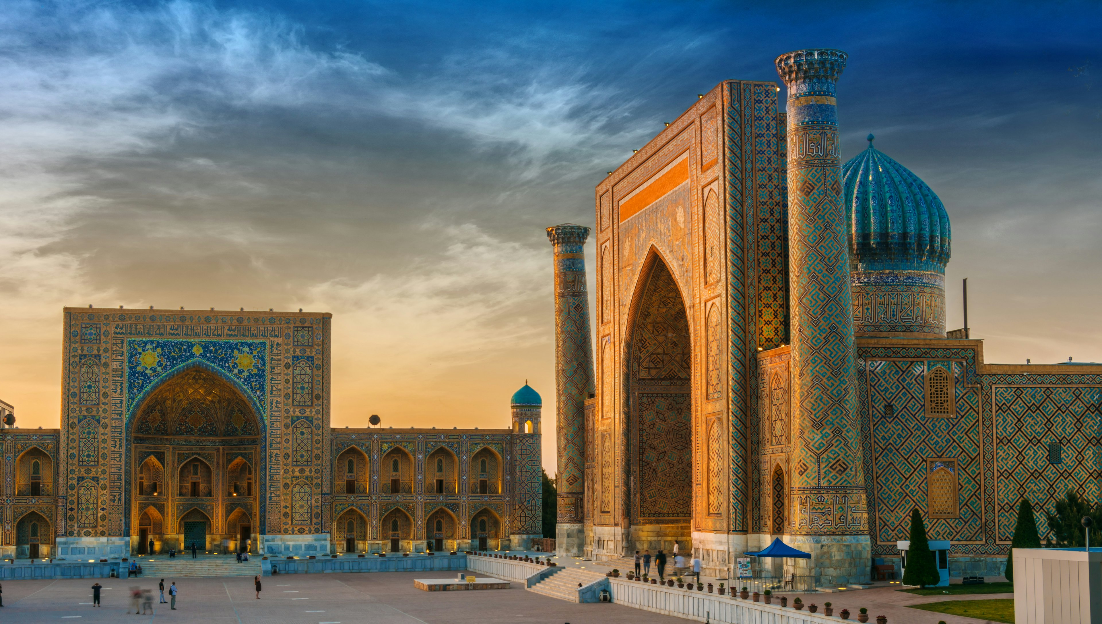 An ancient city square lined by mosques covered in intricate tilework