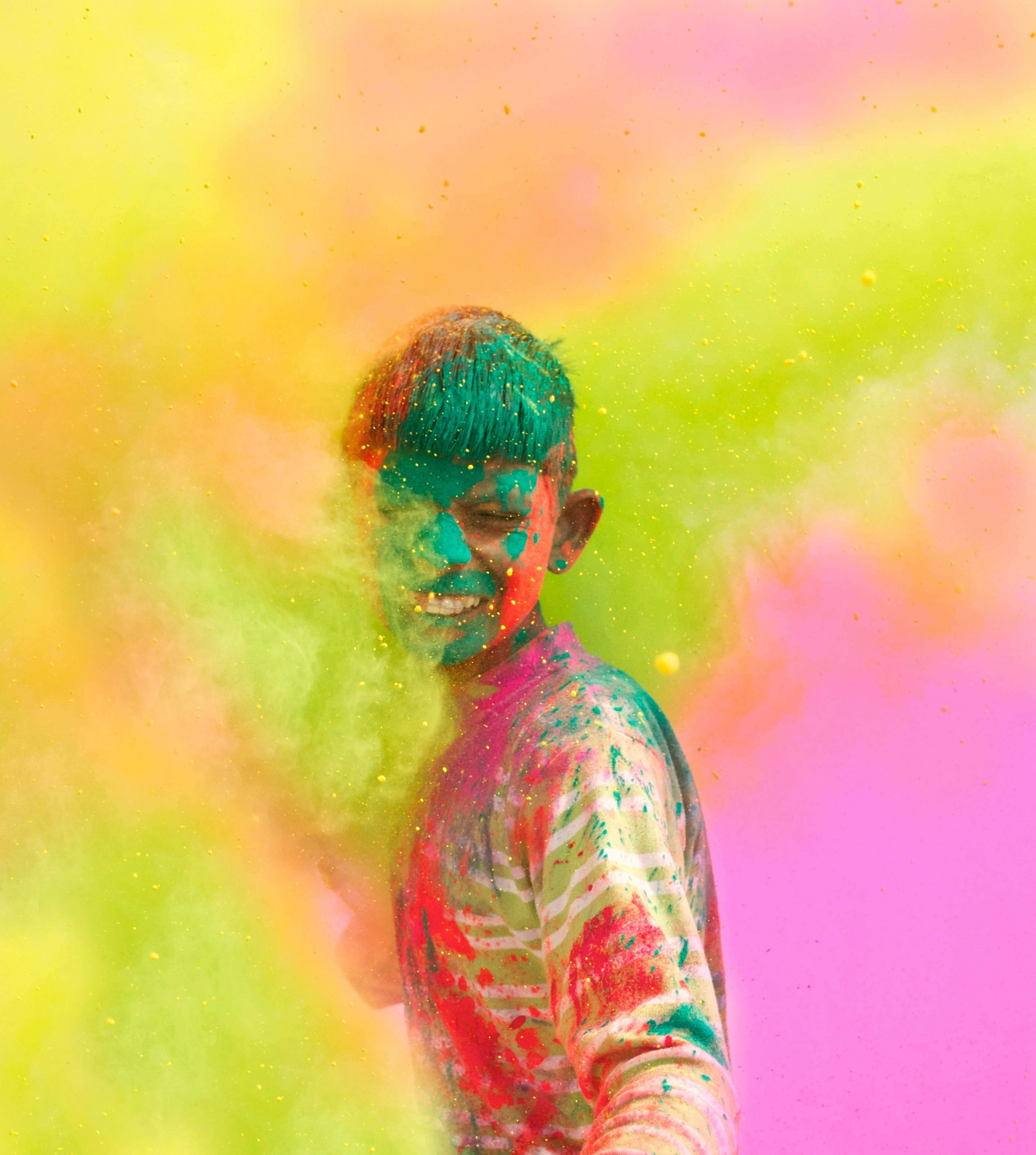 Holi celebrations - Closeup of a boy playing Holi in India.