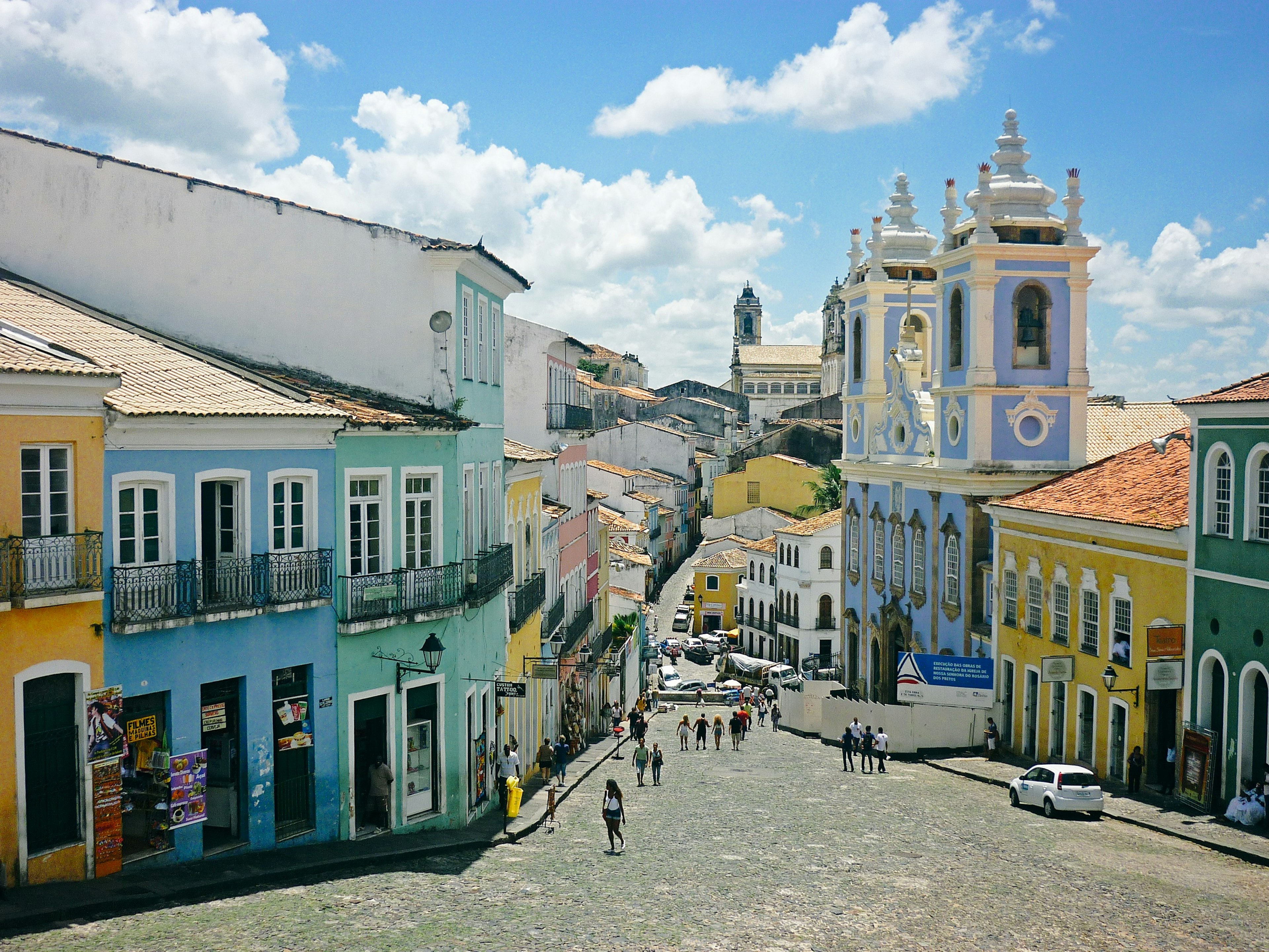 Colorful buildings line a cobbled street in an old town