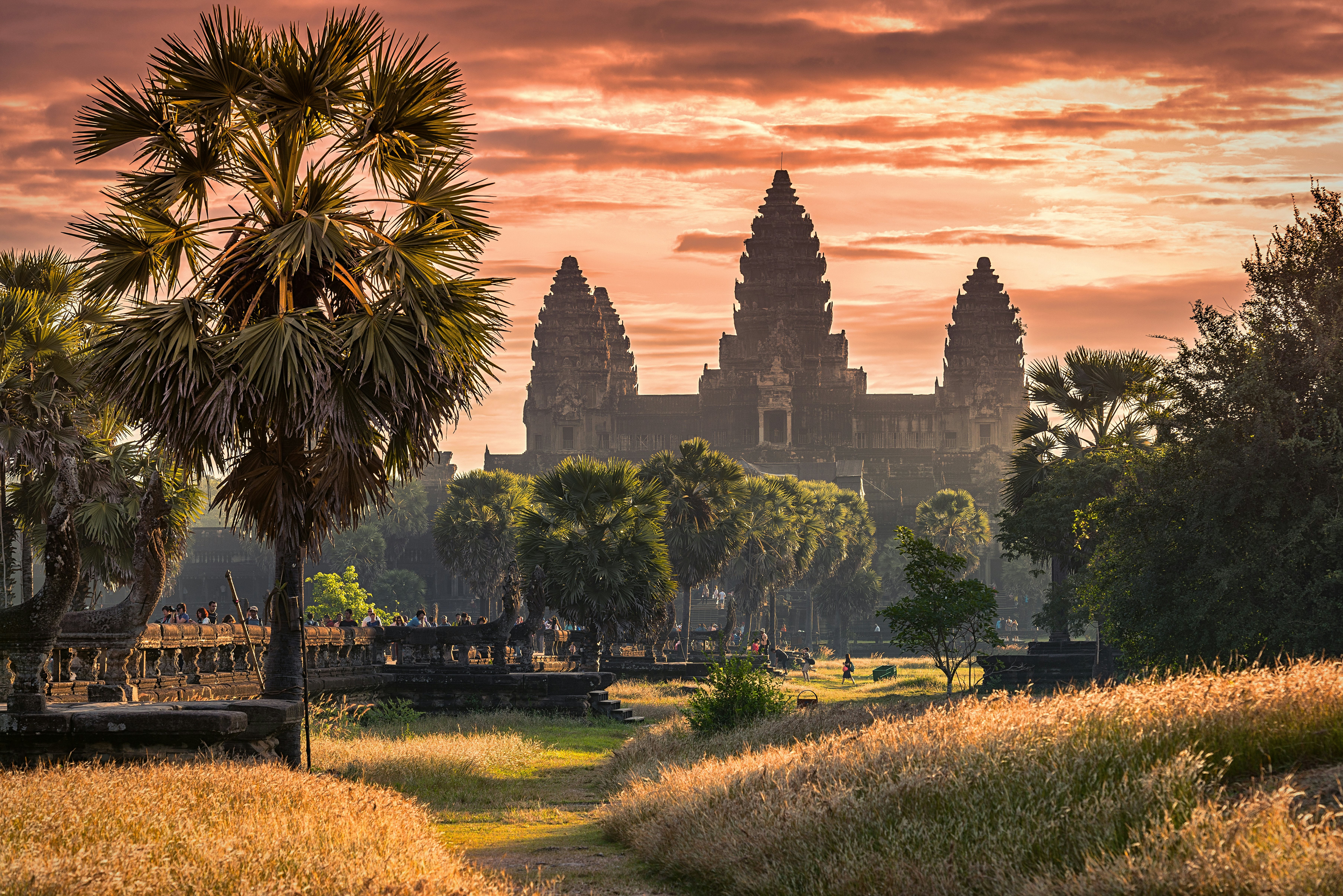 Sunset casts a warm light over Angkor Wat in Cambodia at sunset.