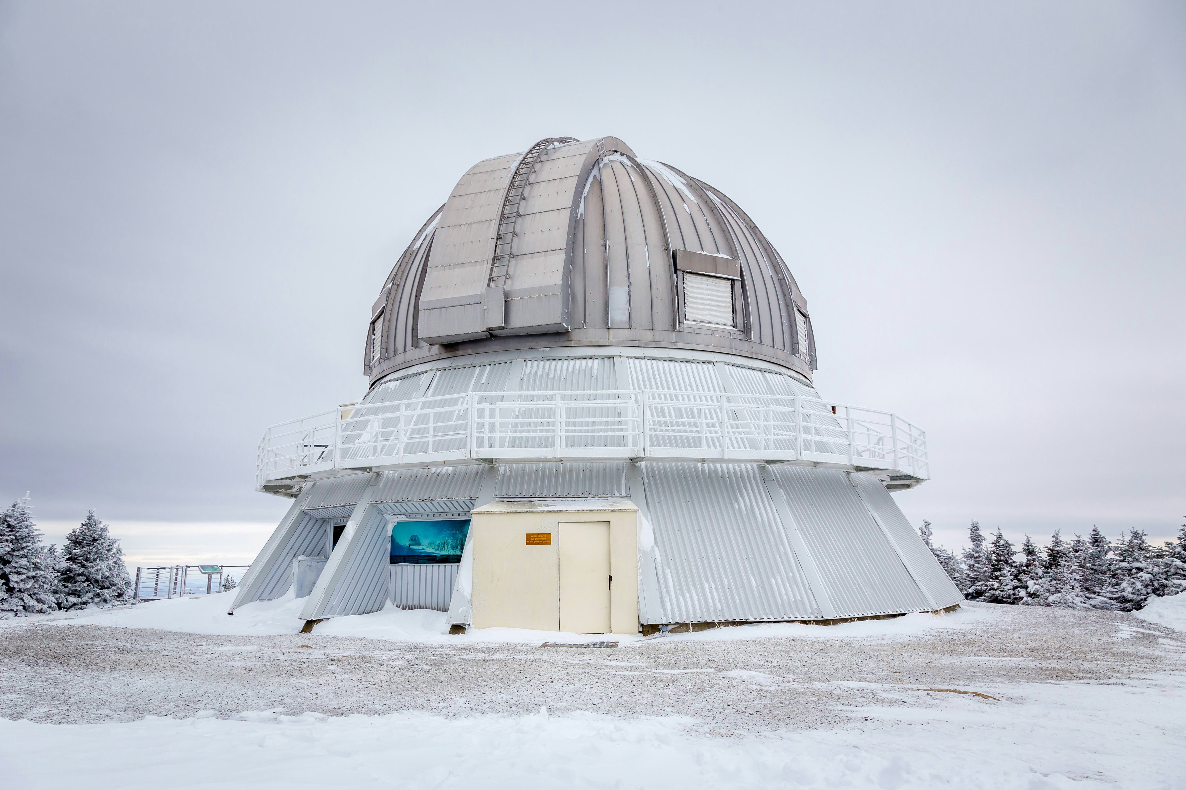 A large domed observatory in a snow-covered landscape