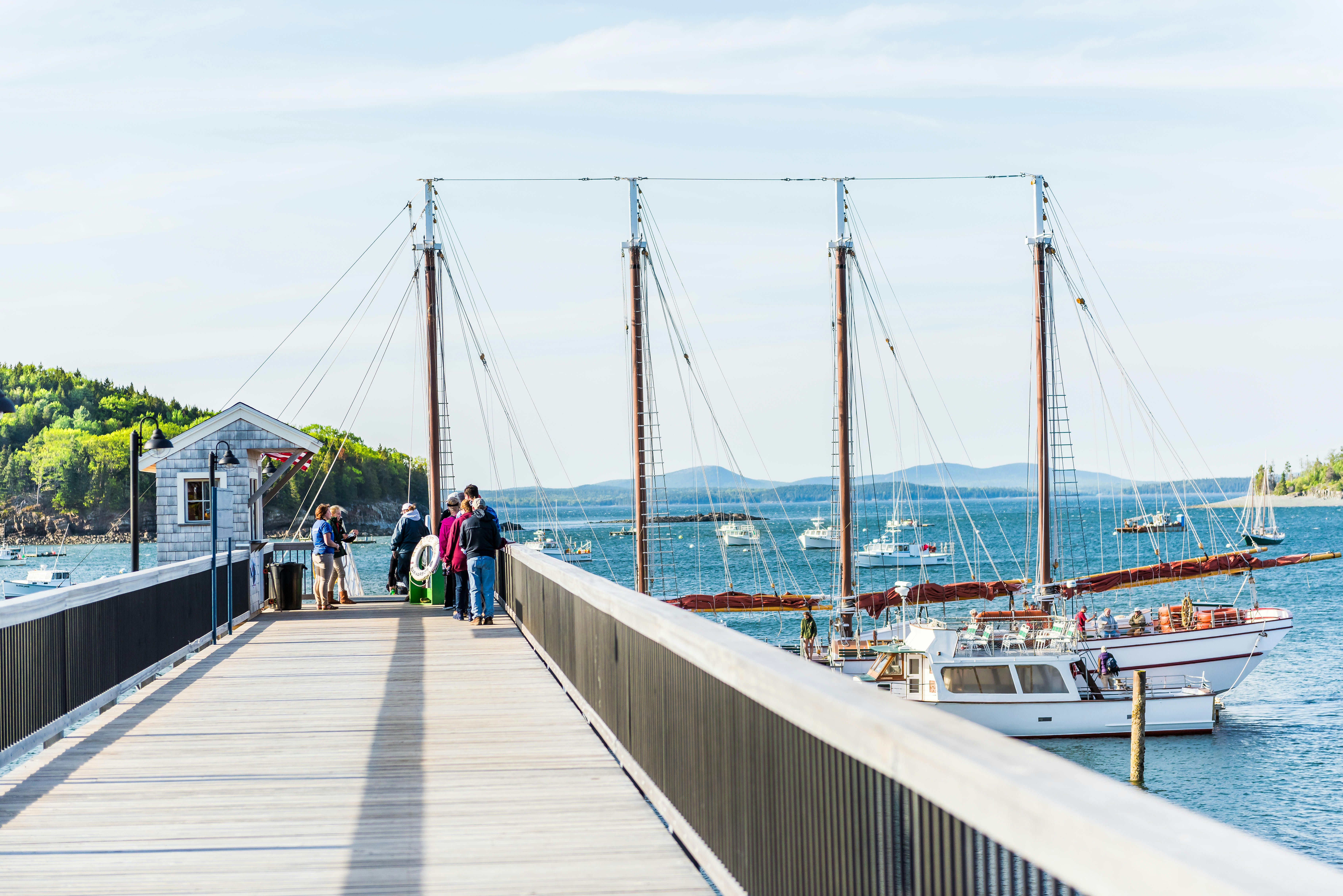 Bar Harbor, USA - June 8, 2017: Pier with tour ship sail boat Margaret Todd Windjammer and people boarding in summer.