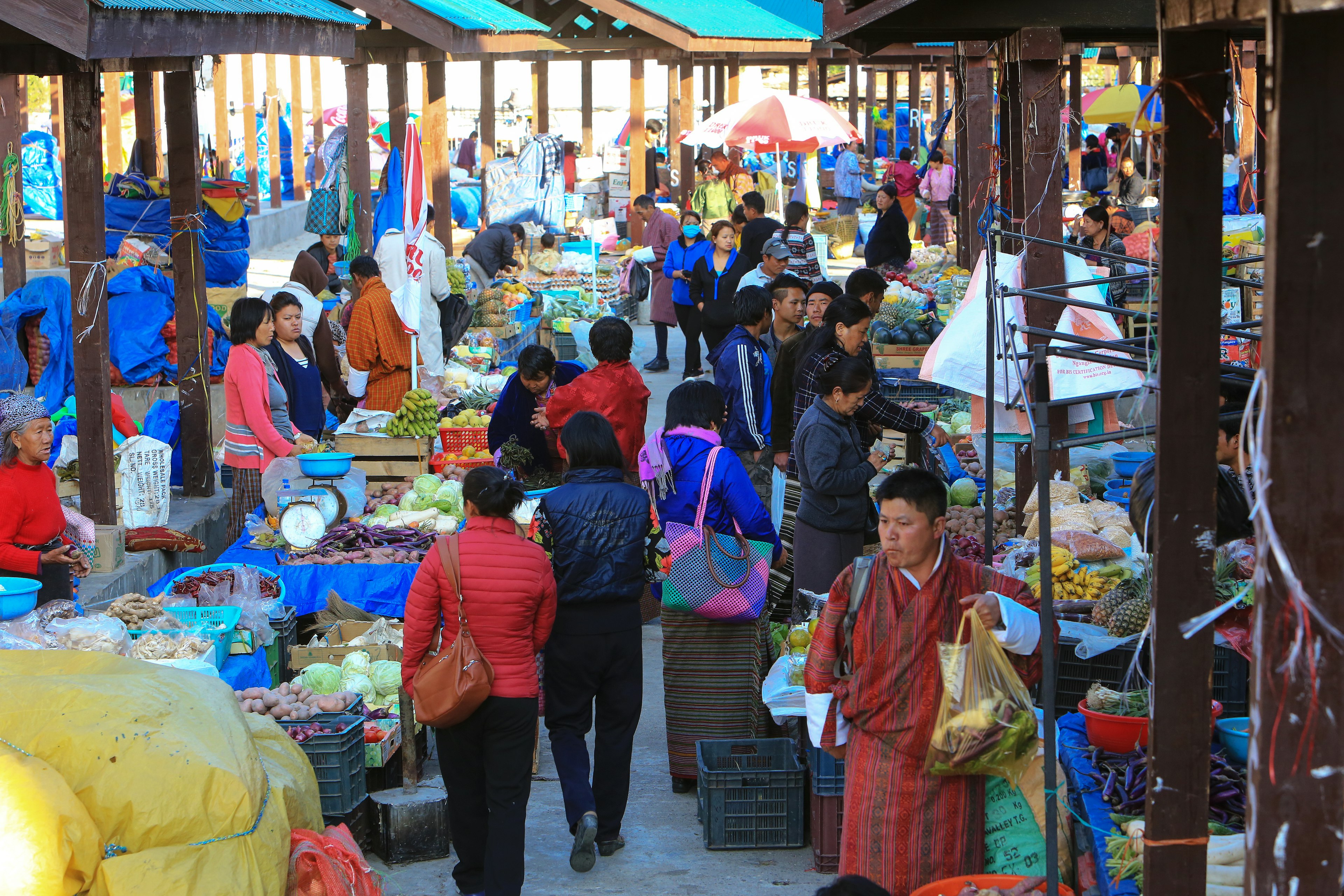 Bhutanese people shopping for vegetables in Paro's market, Bhutan.