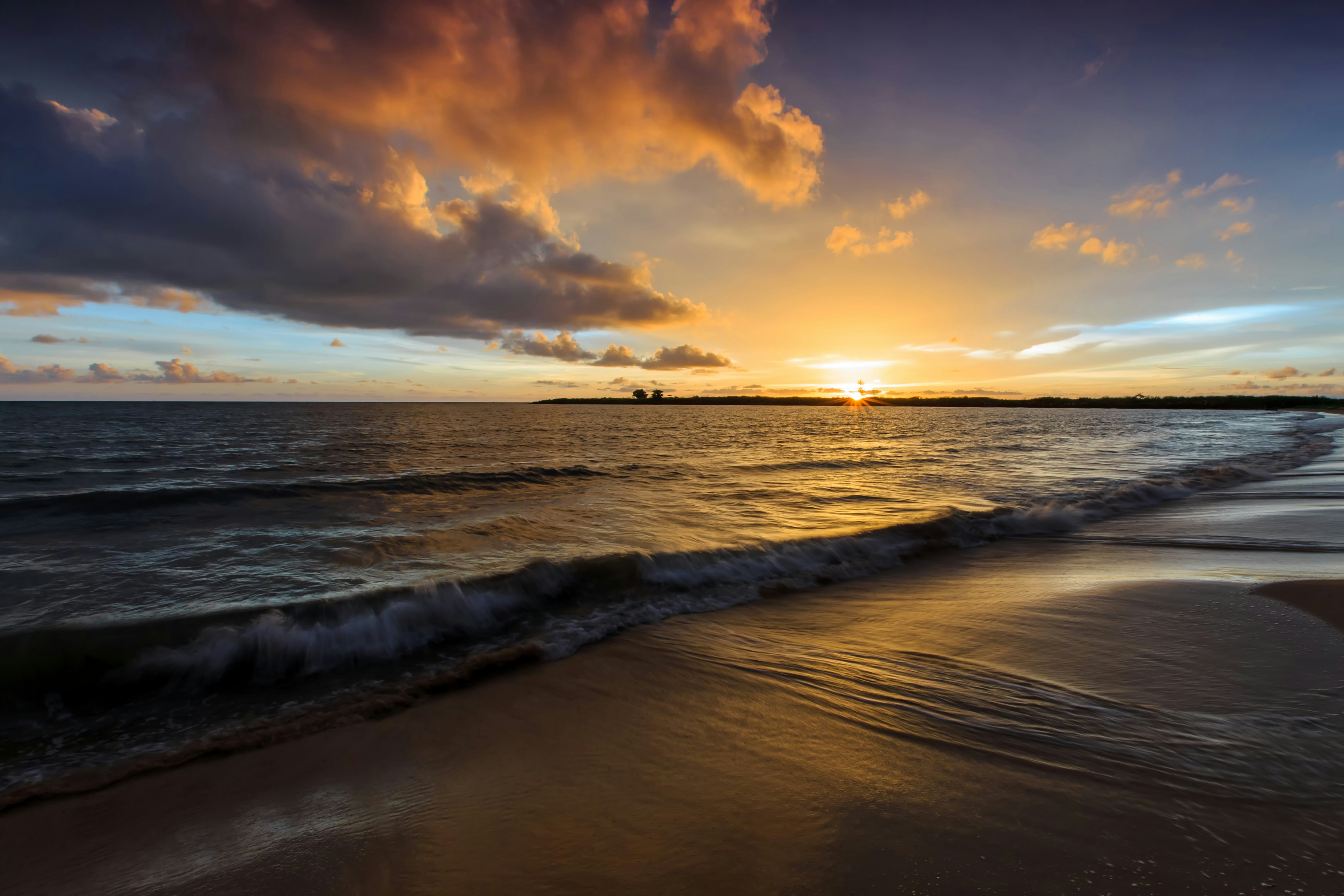 A sunset view over the waves on a beach at Koh Kong, Cambodia.