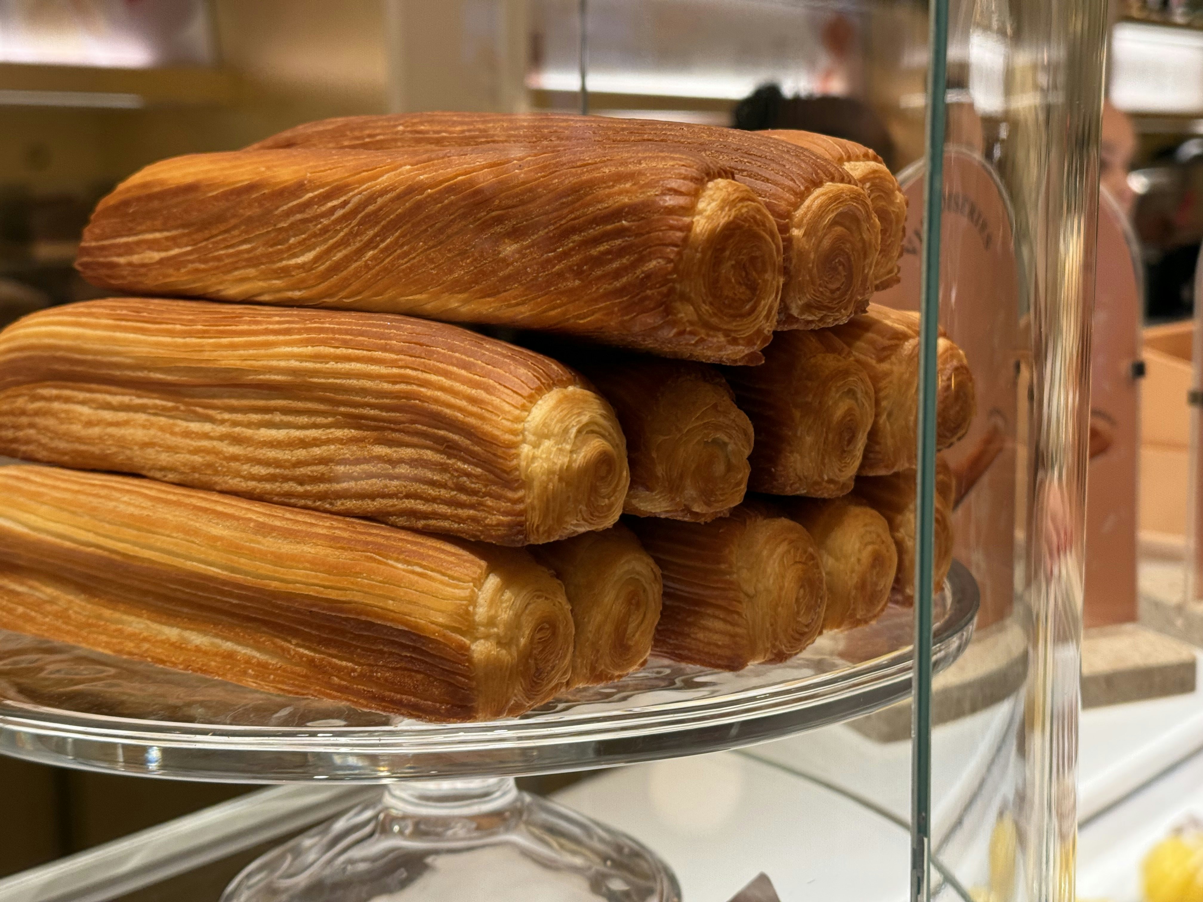 Elegant croissants on display at the Ritz Paris Le Comptoir bakery in Paris.