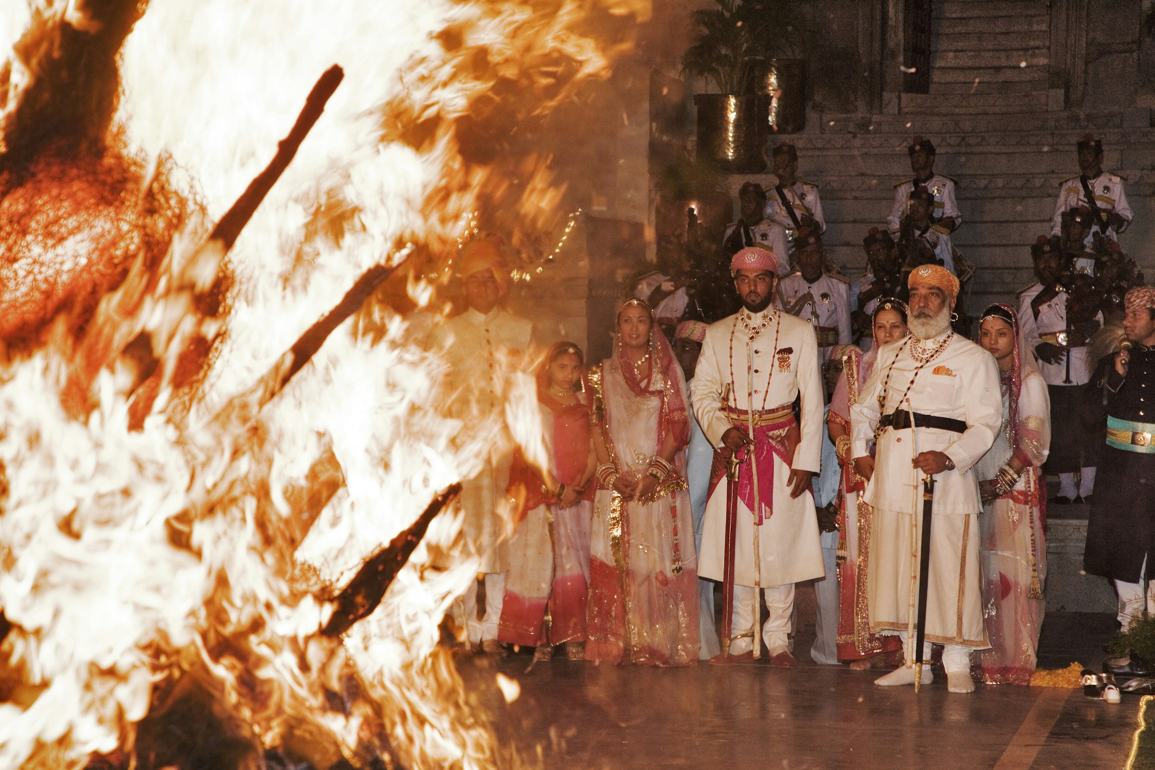 The royal family of Udaipur in Rajasthan observes the Holika Dahan ceremony in the City Palace for Holi.