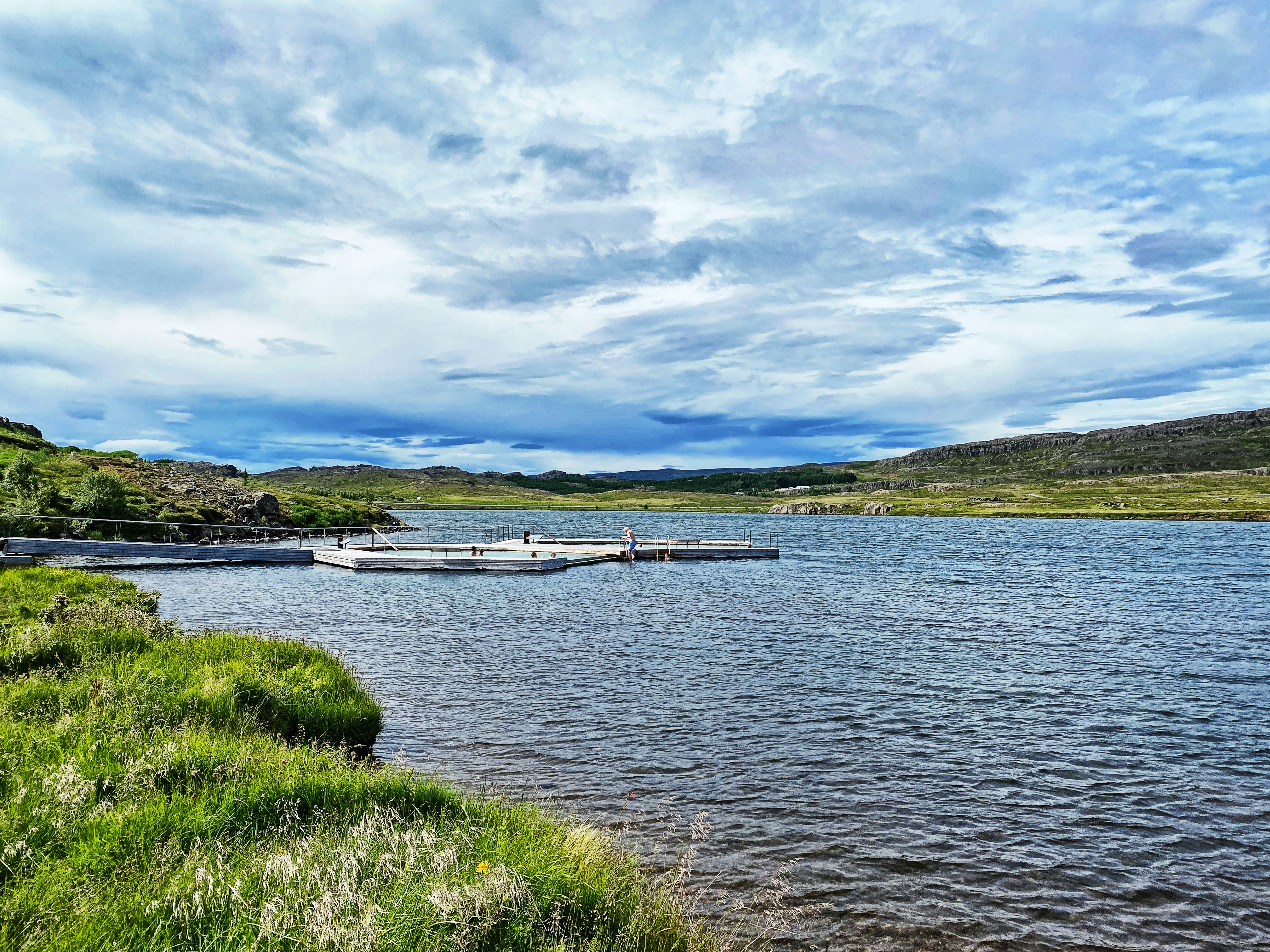 Vök Baths on Lake Urridavatn on a sunny summer day.