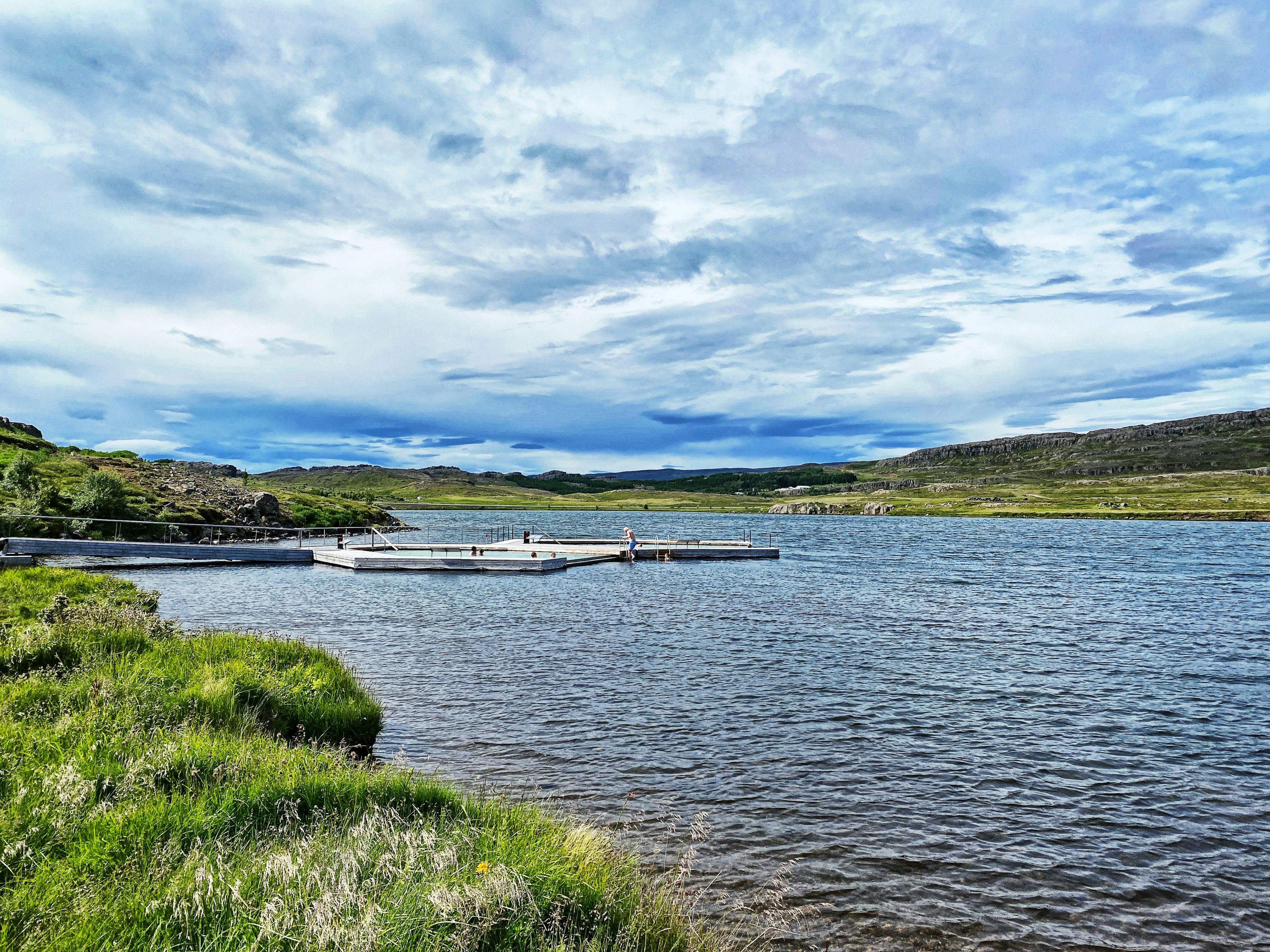 Vök Baths on Lake Urridavatn on a sunny summer day.