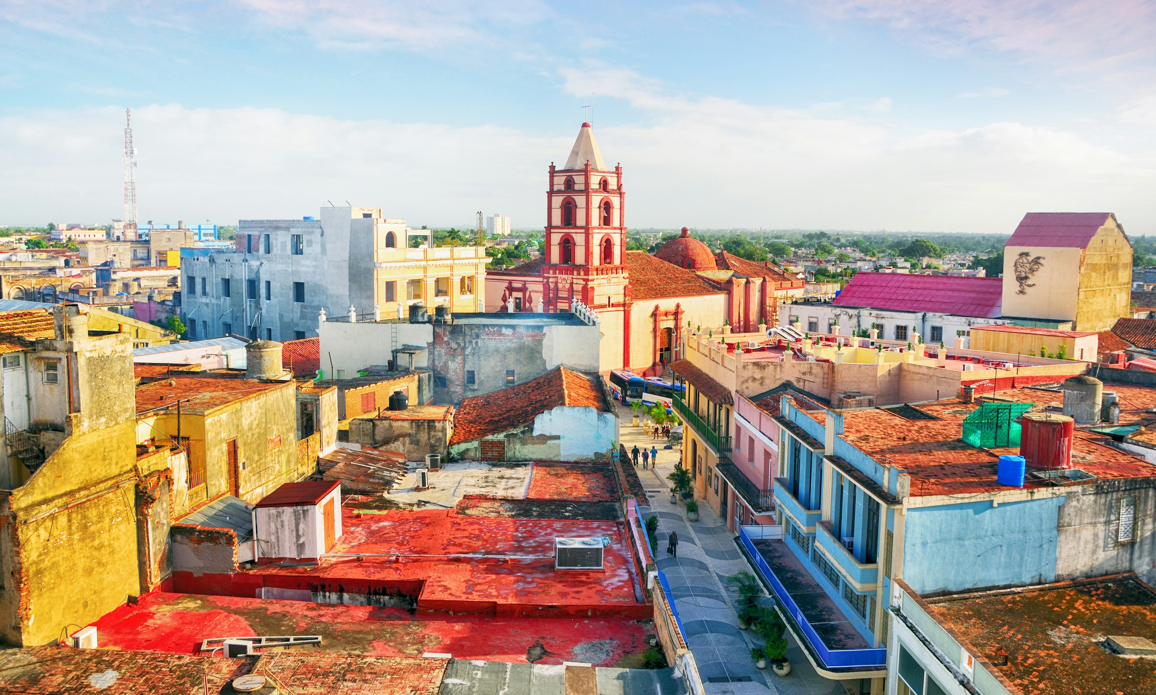 A cityscape of pastel-colored houses and a church