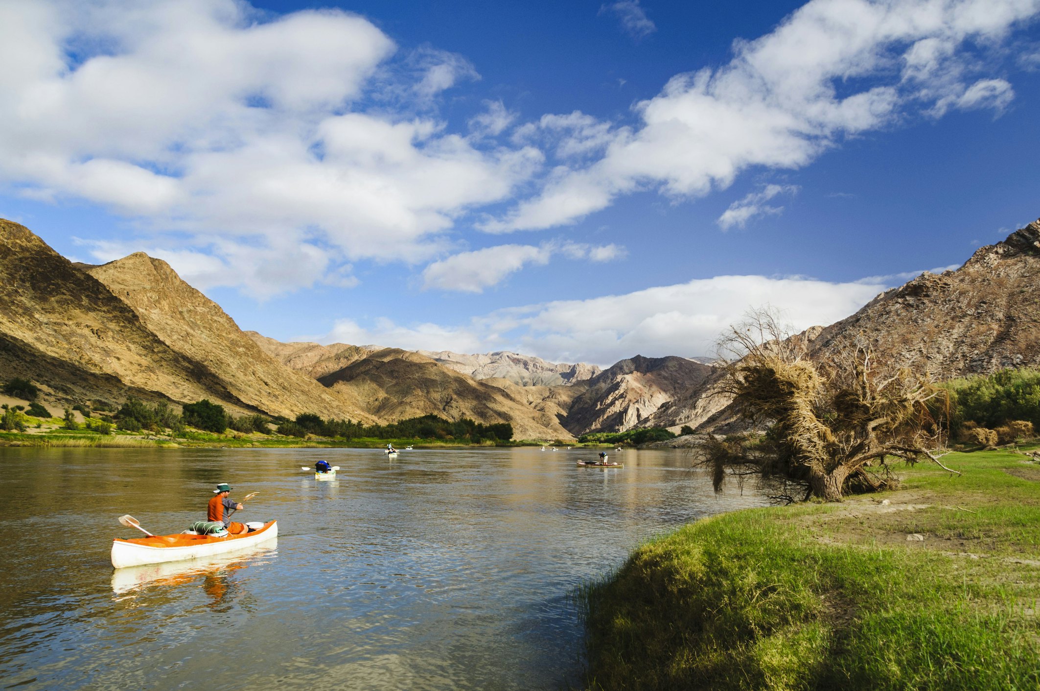 Tourists kayak along the Orange River in Southern Namibia.