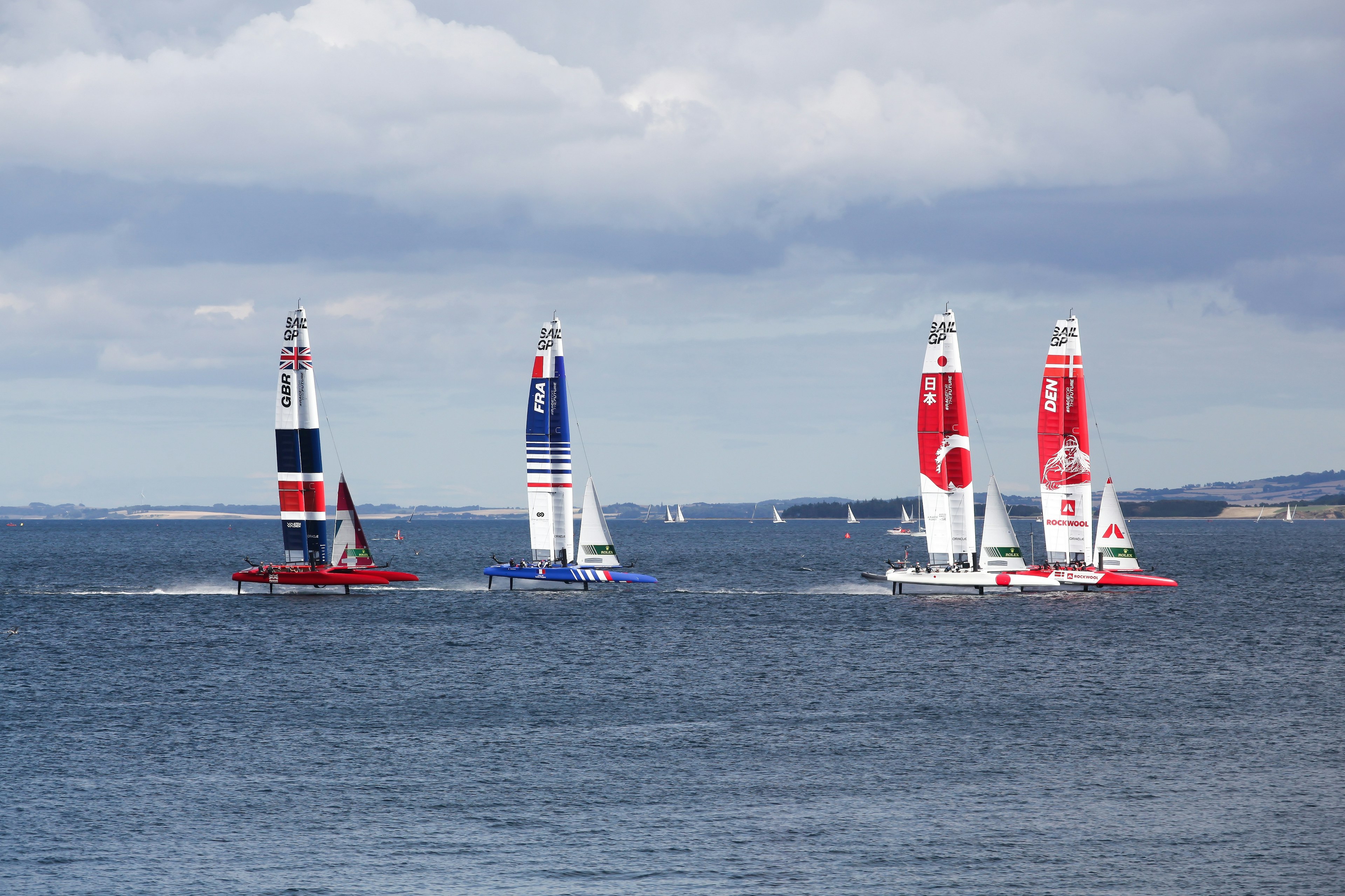 Four high-speed yachts in a harbor