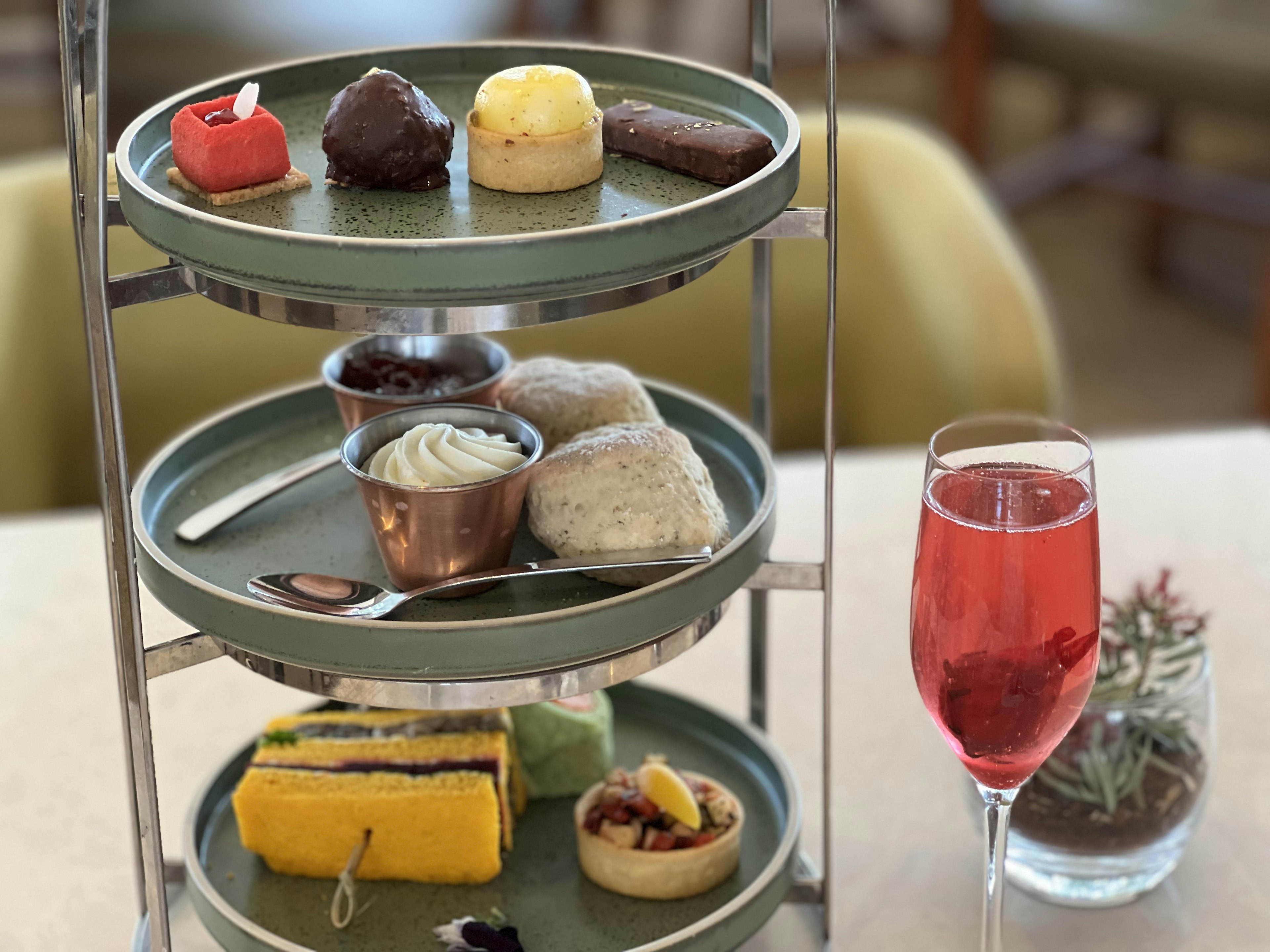 A tiered tea tray with small desserts and cake-like treats on each level