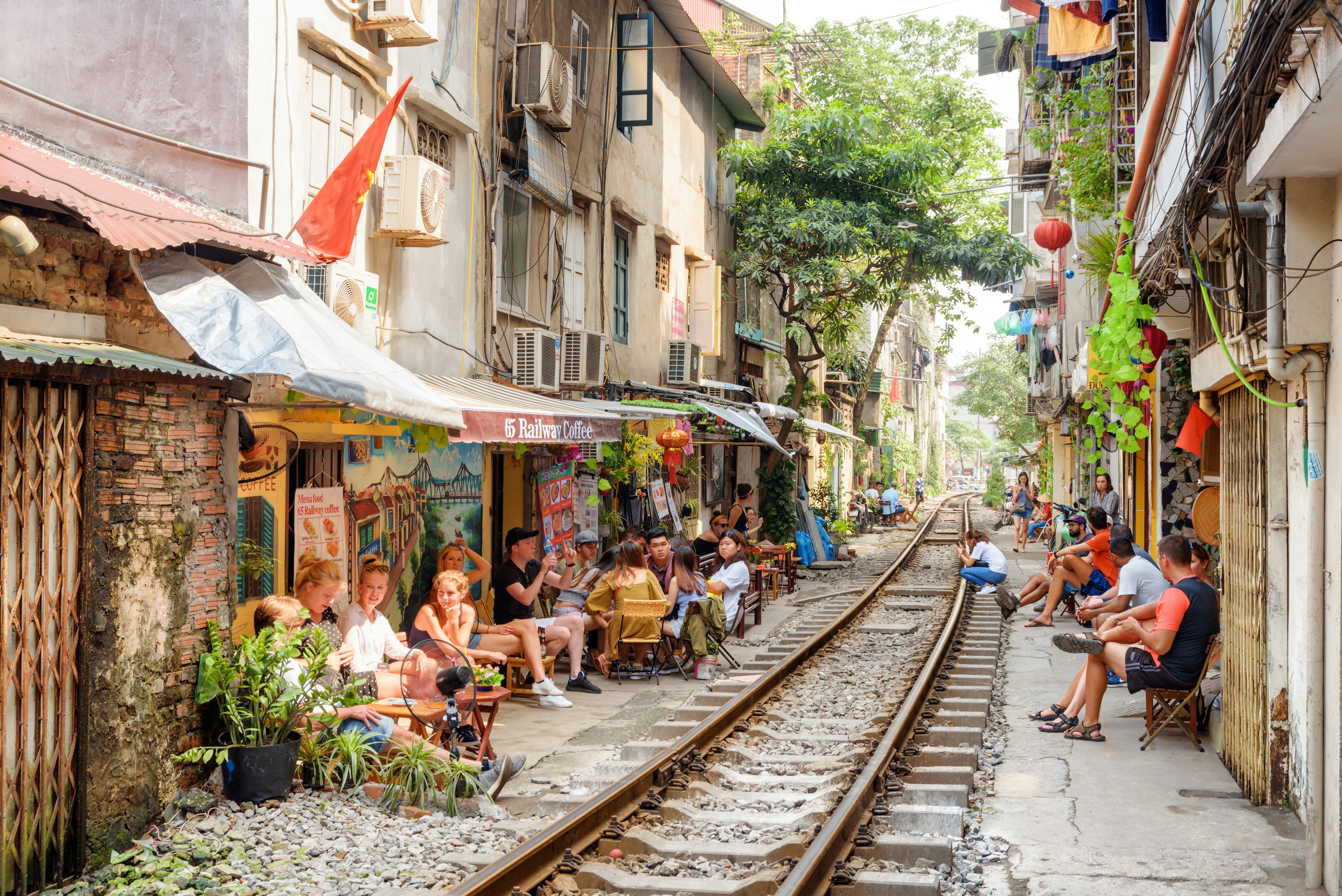 Hanoi, Vietnam - April 18, 2019: Tourists and residents waiting a passing train at the Hanoi Train Street. The narrow street of the Hanoi Old Quarter is a popular tourist attraction of Asia.  License Type: media  Download Time: 2023-04-06T13:08:05.000Z  User: nic.dhoedt_lonelyplanet  Is Editorial: Yes  purchase_order: