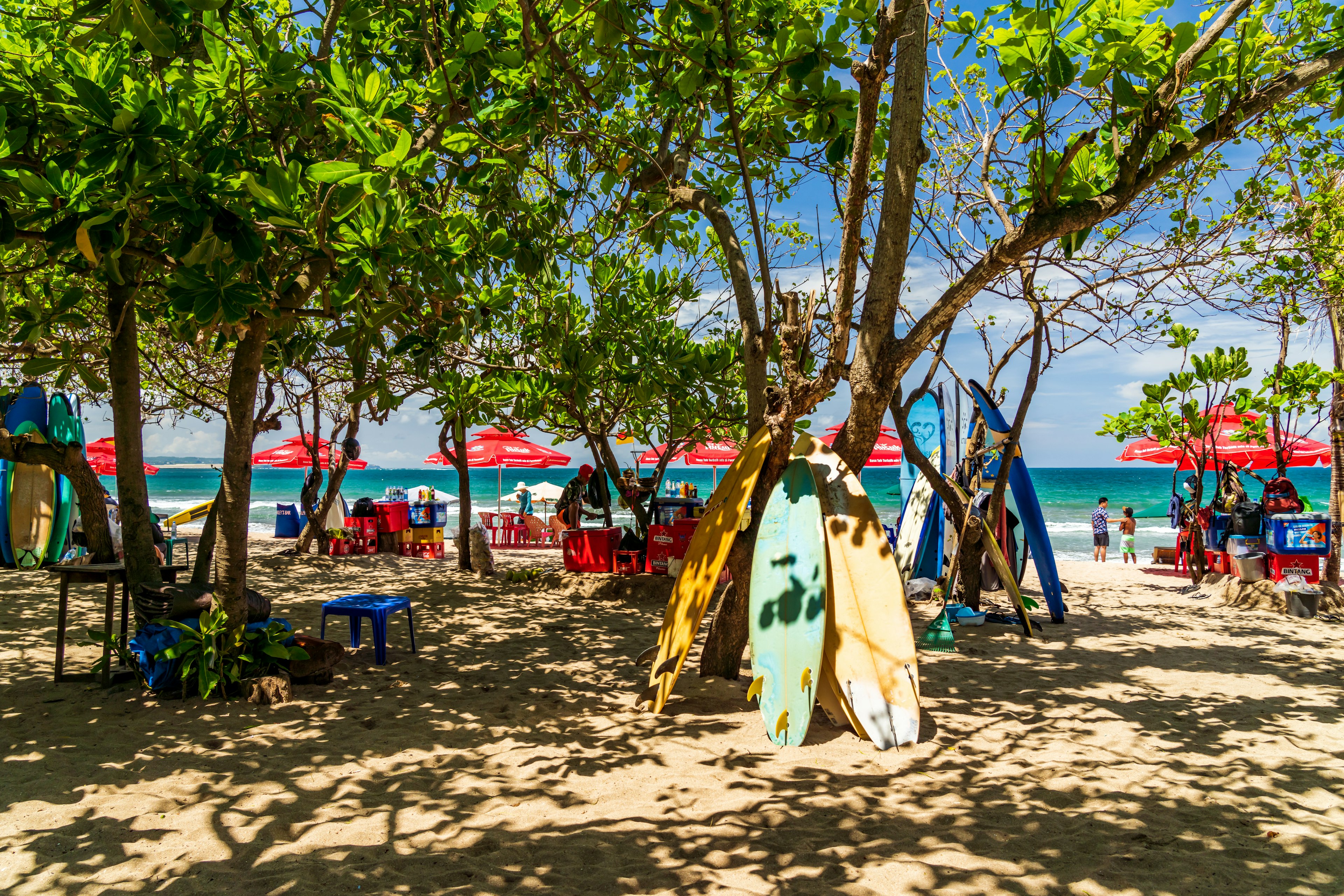 Surfboards piled up by the sand on famous Kuta beach in Bali, Indonesia.