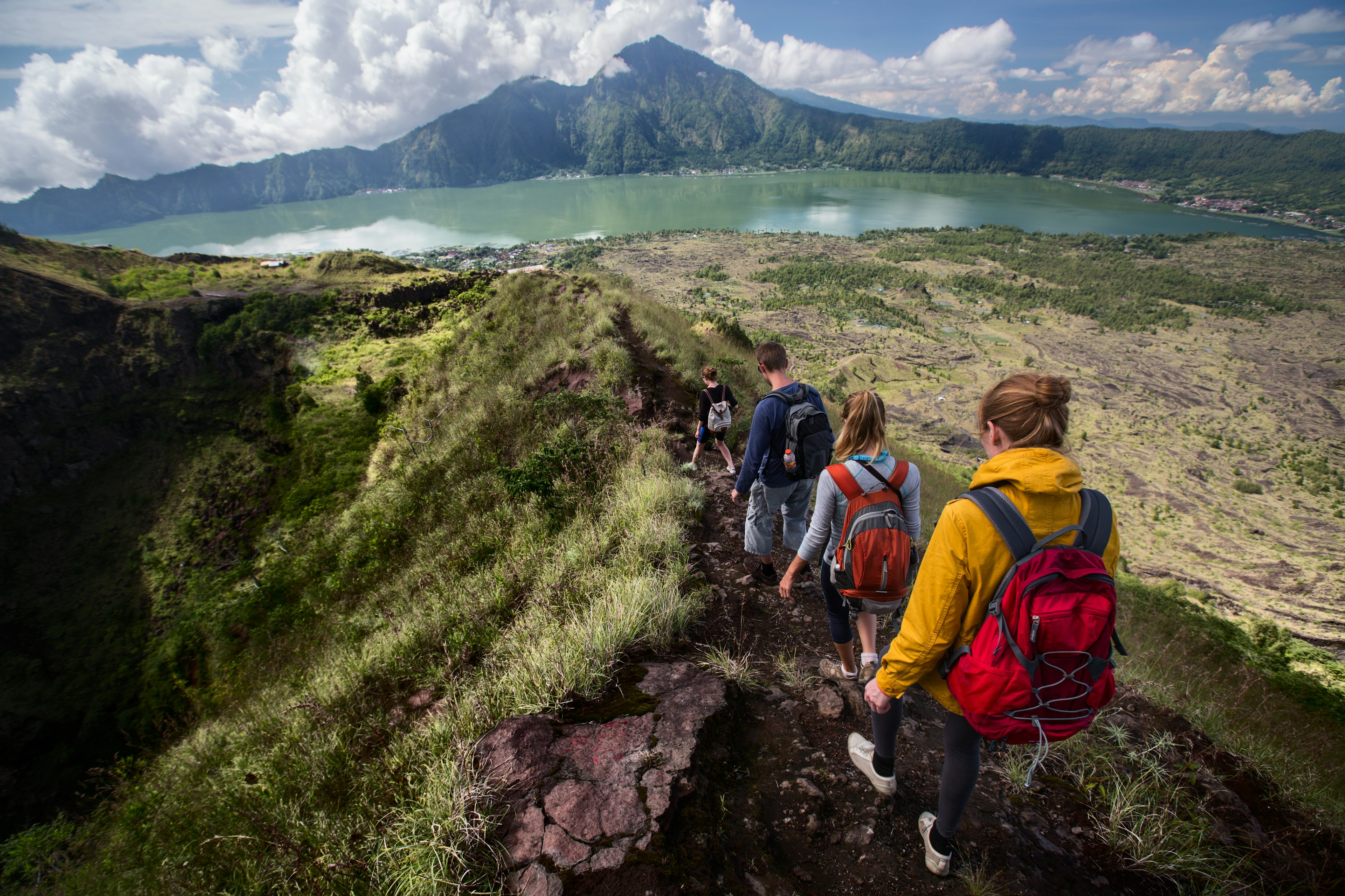 Group of hikers walking on the caldera of the Batur volcano, Bali, Indonesia.