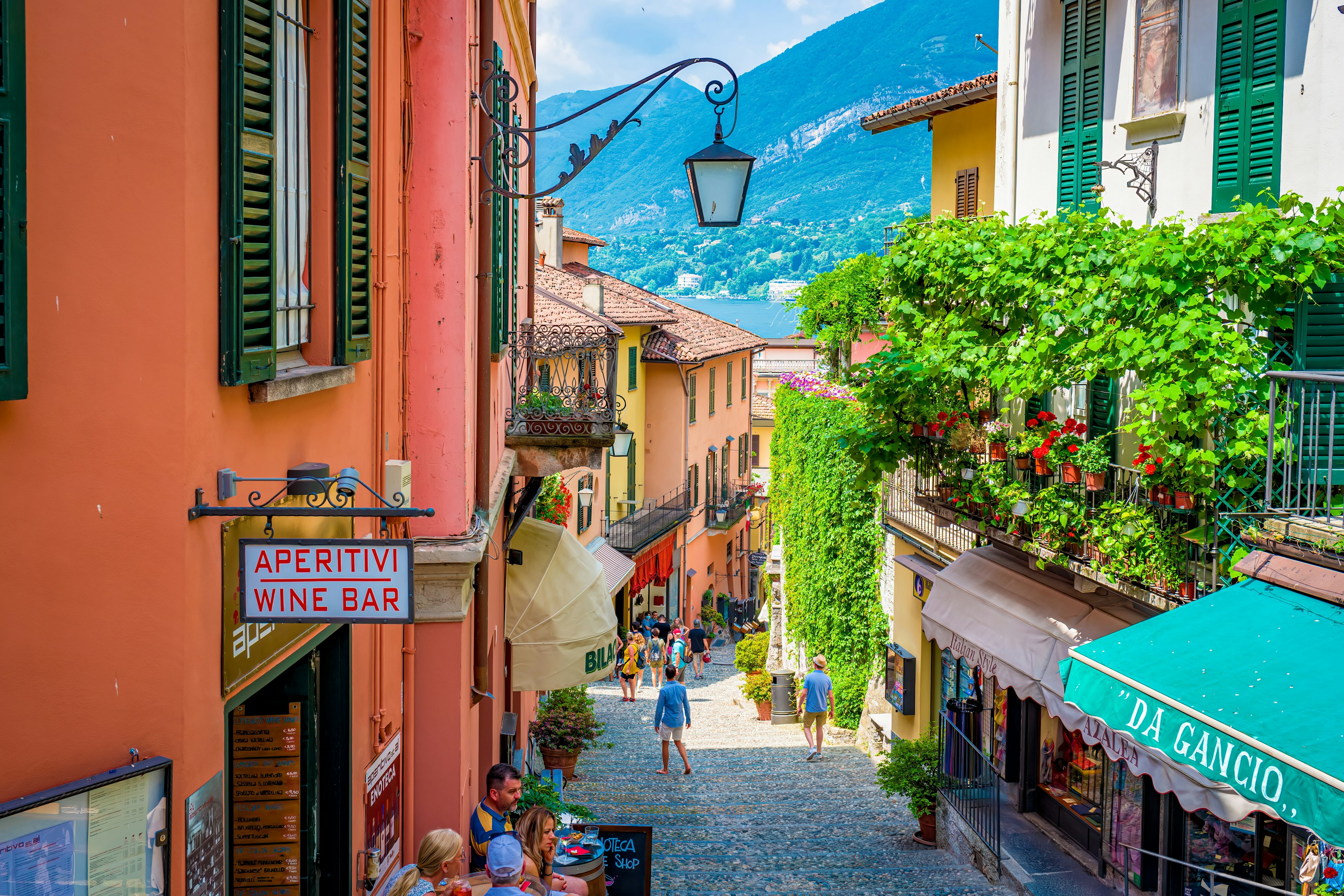 View of Lake Como from the top of a colorful street in Bellagio.