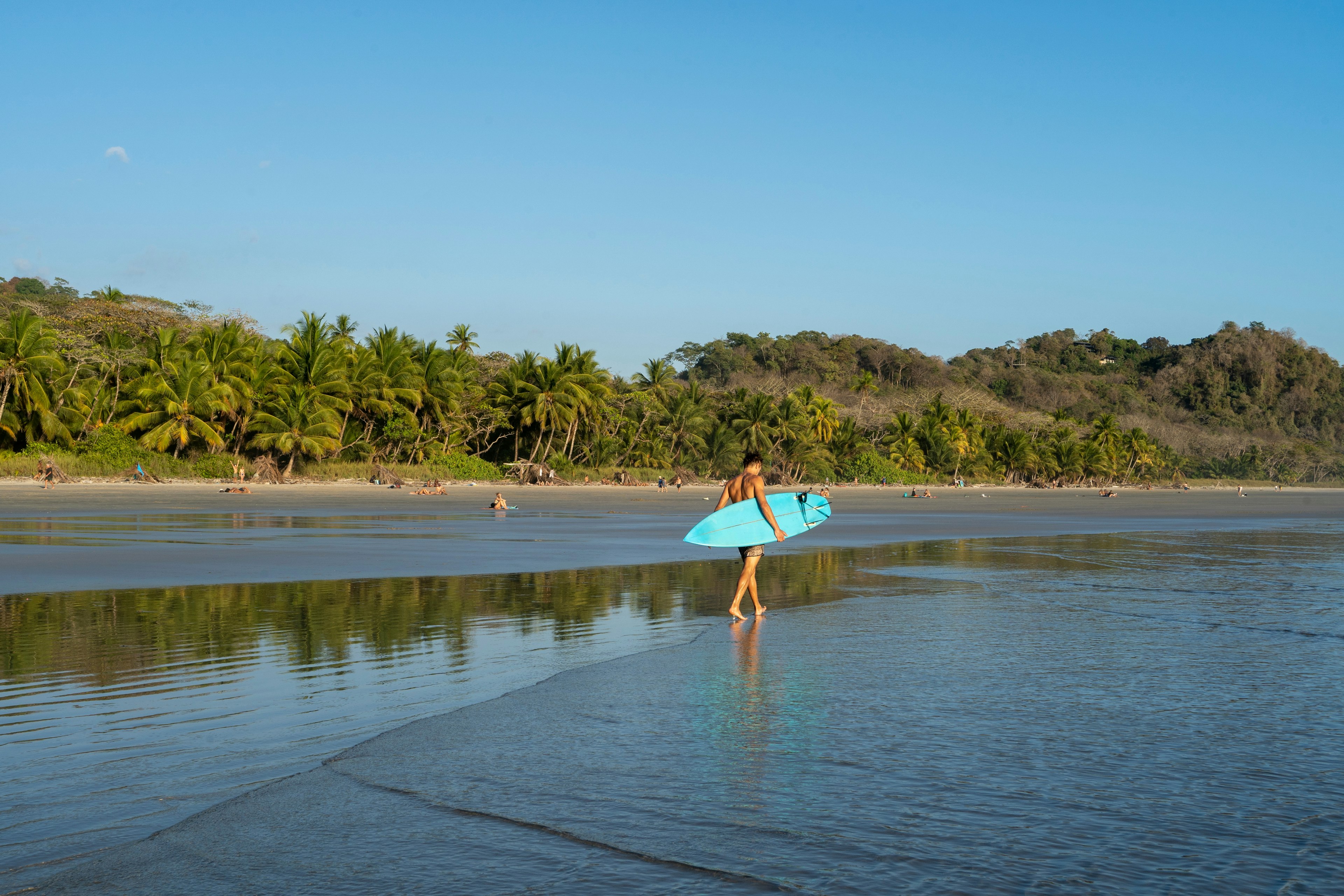 Surfer walking at the beach at playa Hermosa.