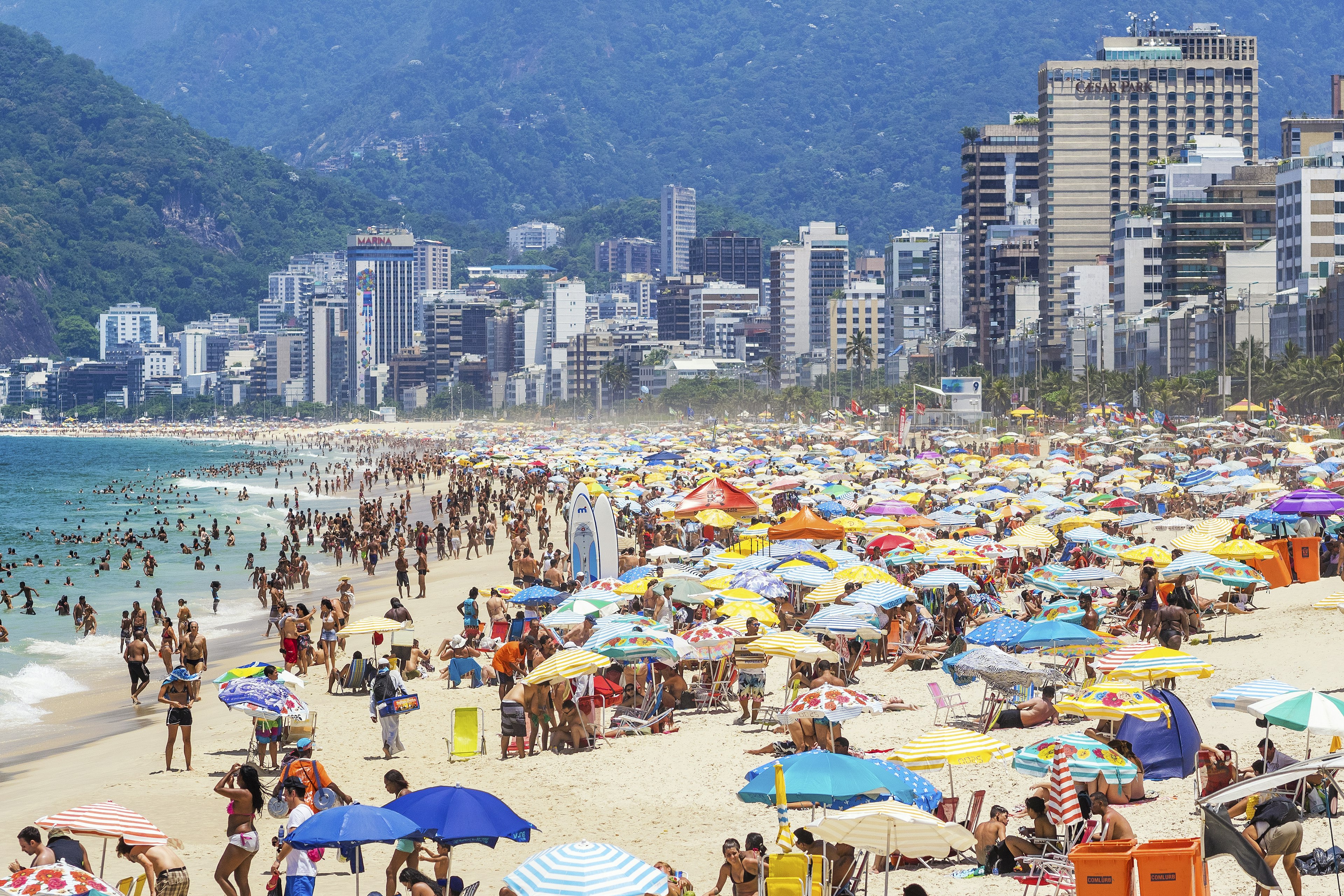 Tourists and locals enjoying the summer at the famous Ipanema Beach in Rio de Janeiro, Brazil.