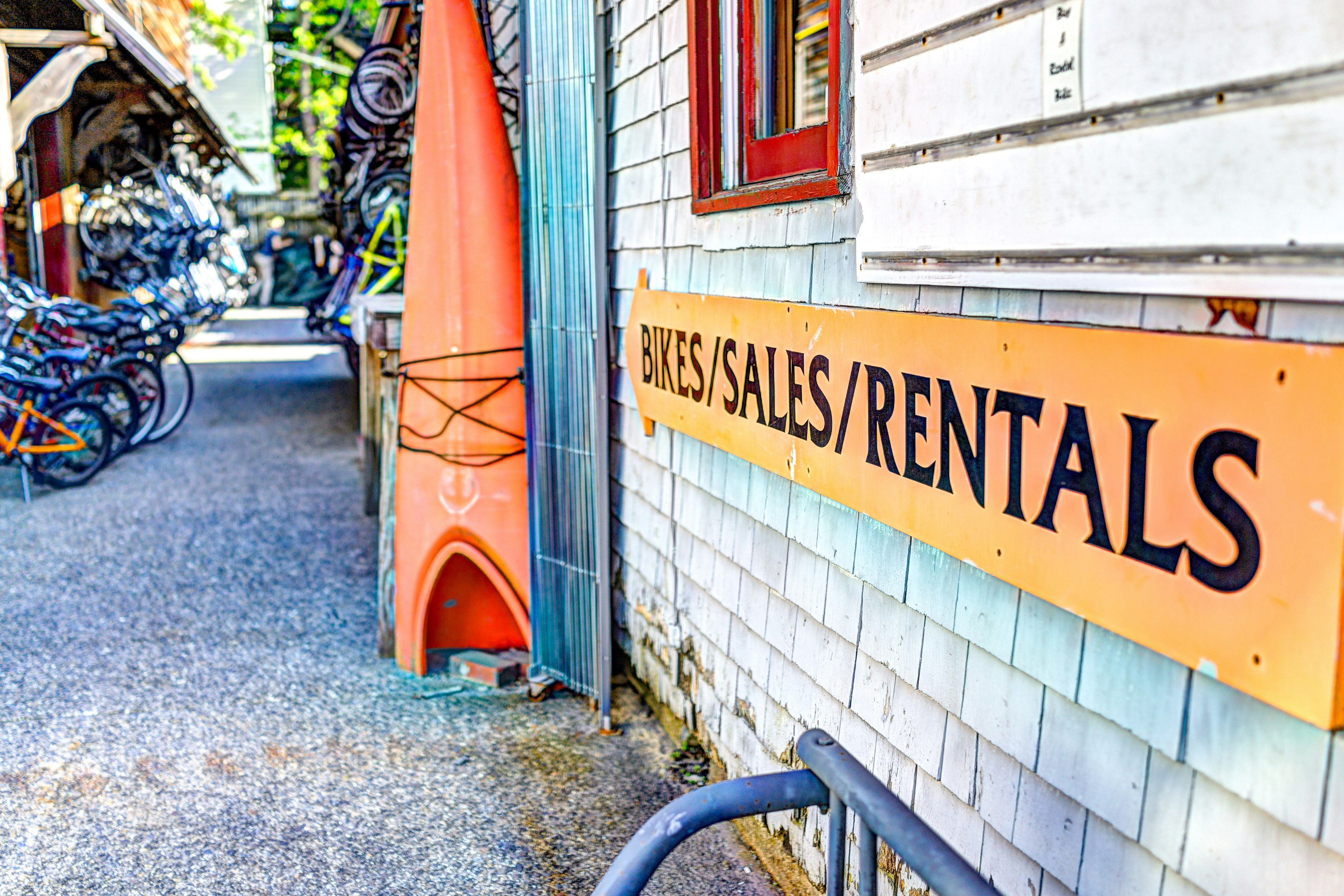 Bar Harbor, USA - June 8, 2017: Acacia Bike colorful store sign with many bicycles and kayaks in downtown village